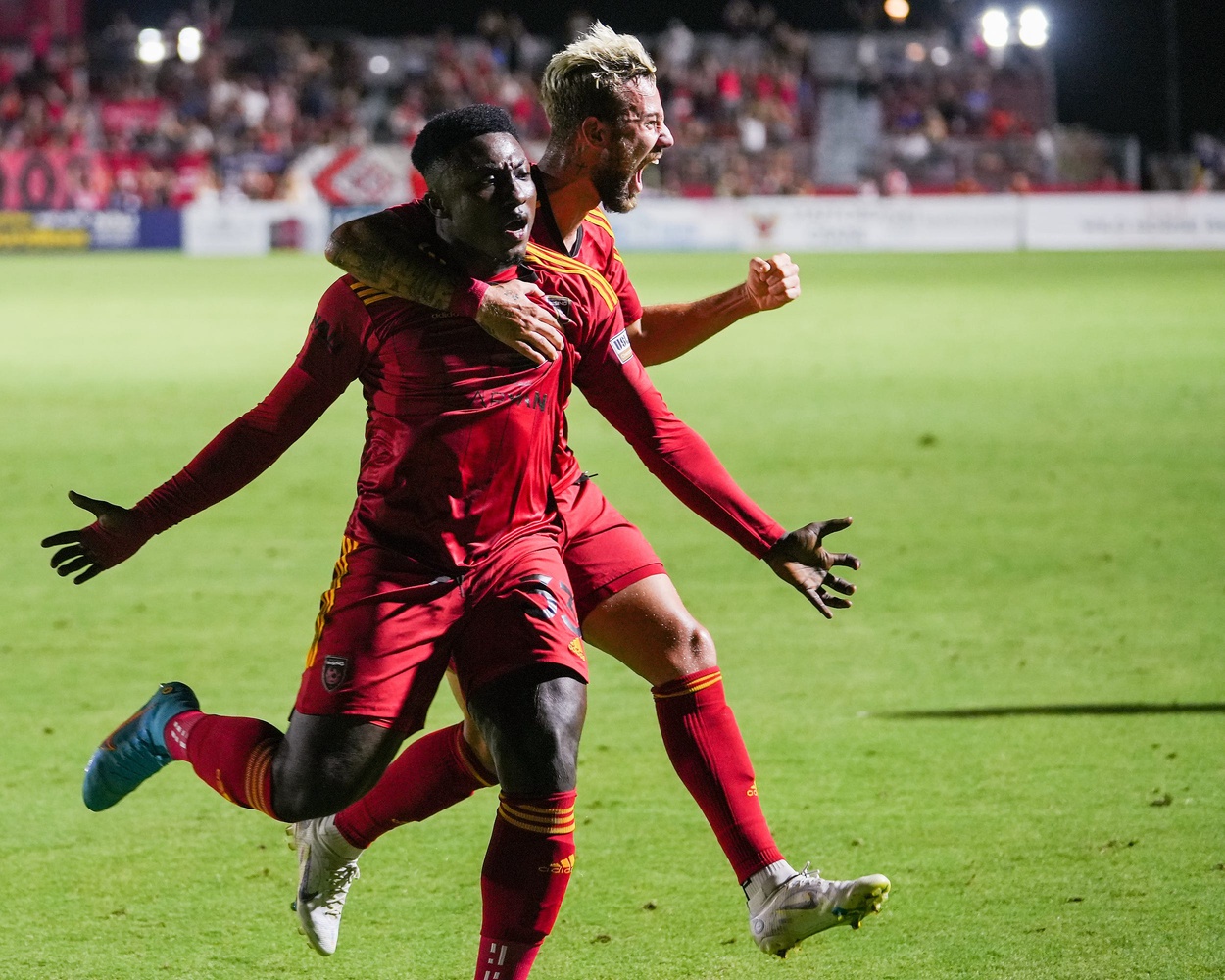 Phoenix Rising FC forward Richmond Antwi (33), left, and Phoenix Rising FC defender Ryan Flood (4), right, celebrate Antwi's goal to tie the match at two goals during the second half against Orange County SC on Saturday, July 2, 2022, in Chandler.