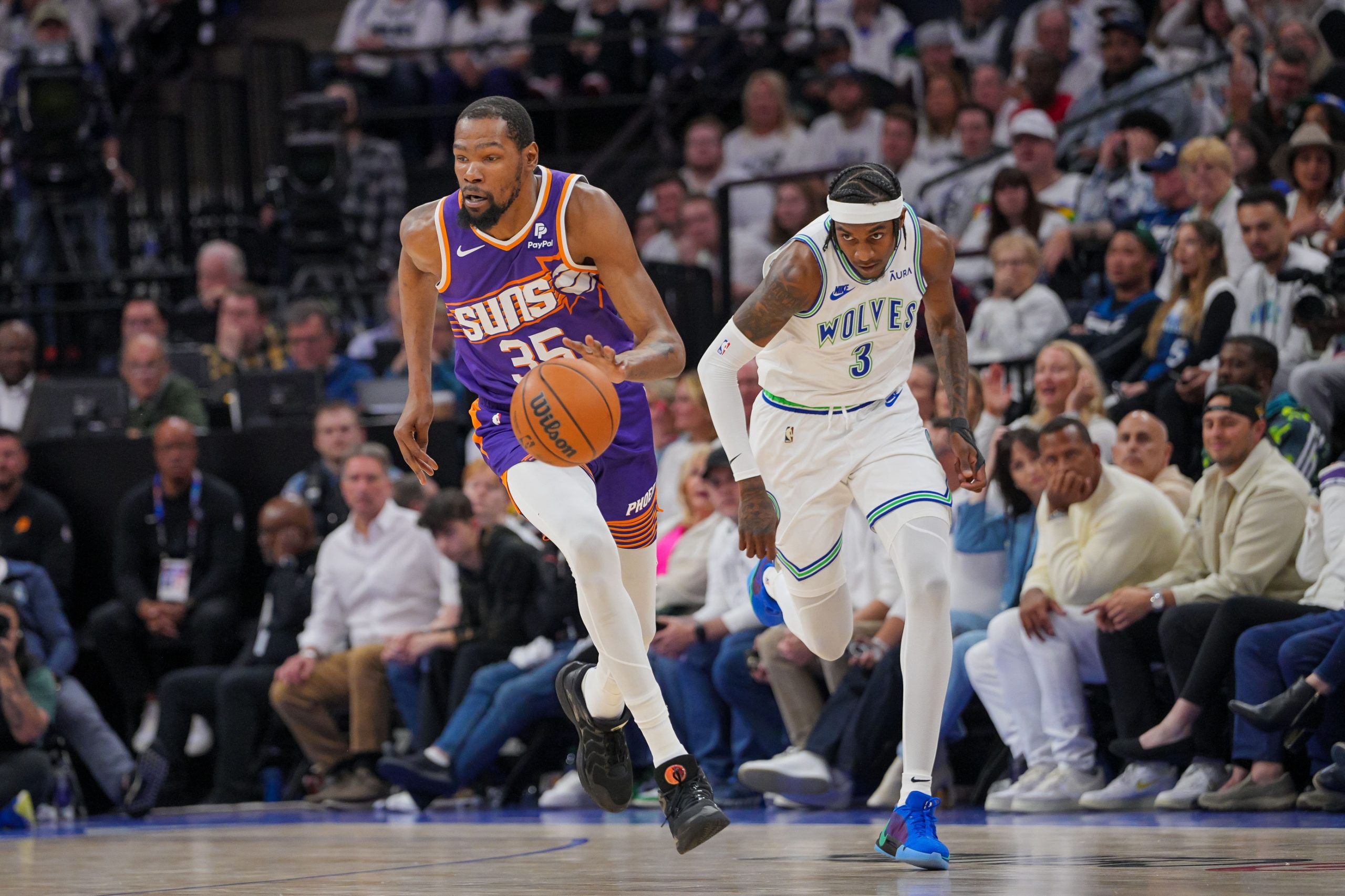 Apr 23, 2024; Minneapolis, Minnesota, USA; Phoenix Suns forward Kevin Durant (35) dribbles against Minnesota Timberwolves forward Jaden McDaniels (3) in the second quarter during game two of the first round for the 2024 NBA playoffs at Target Center. Mandatory Credit: Brad Rempel-USA TODAY Sports