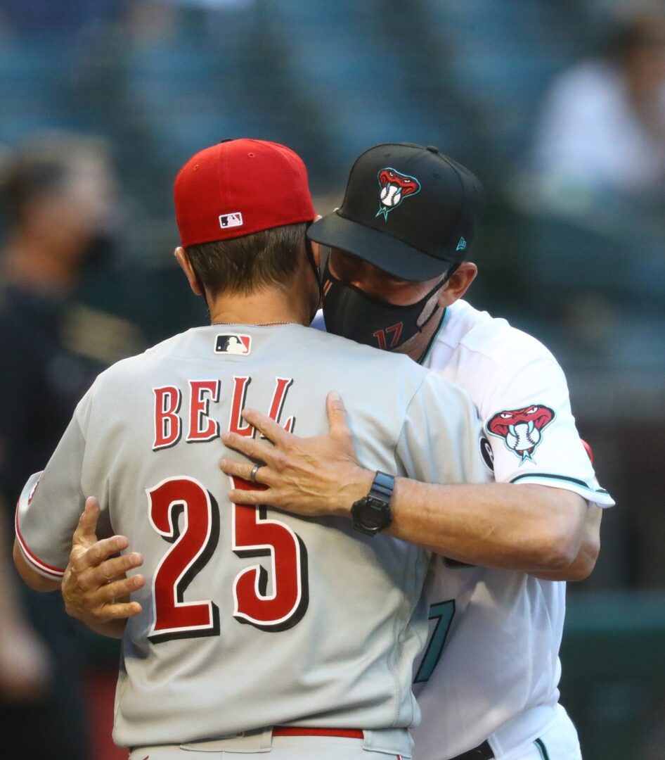 Diamondbacks manager Torey Lovullo embraces Cincinnati Reds manager David Bell before the game.