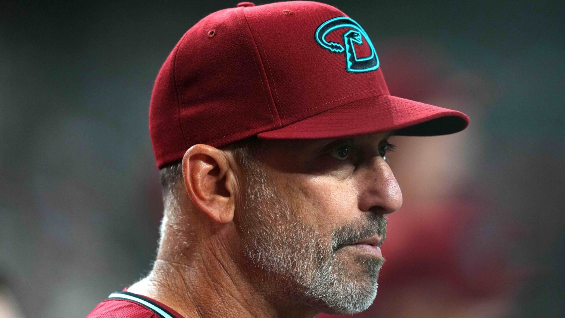 Arizona Diamondbacks manager Torey Lovullo looks out to the field from his dugout.