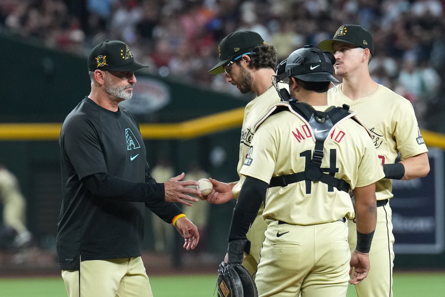 Diamondbacks manager Torey Lovullo takes the baseball from Zac Gallen.