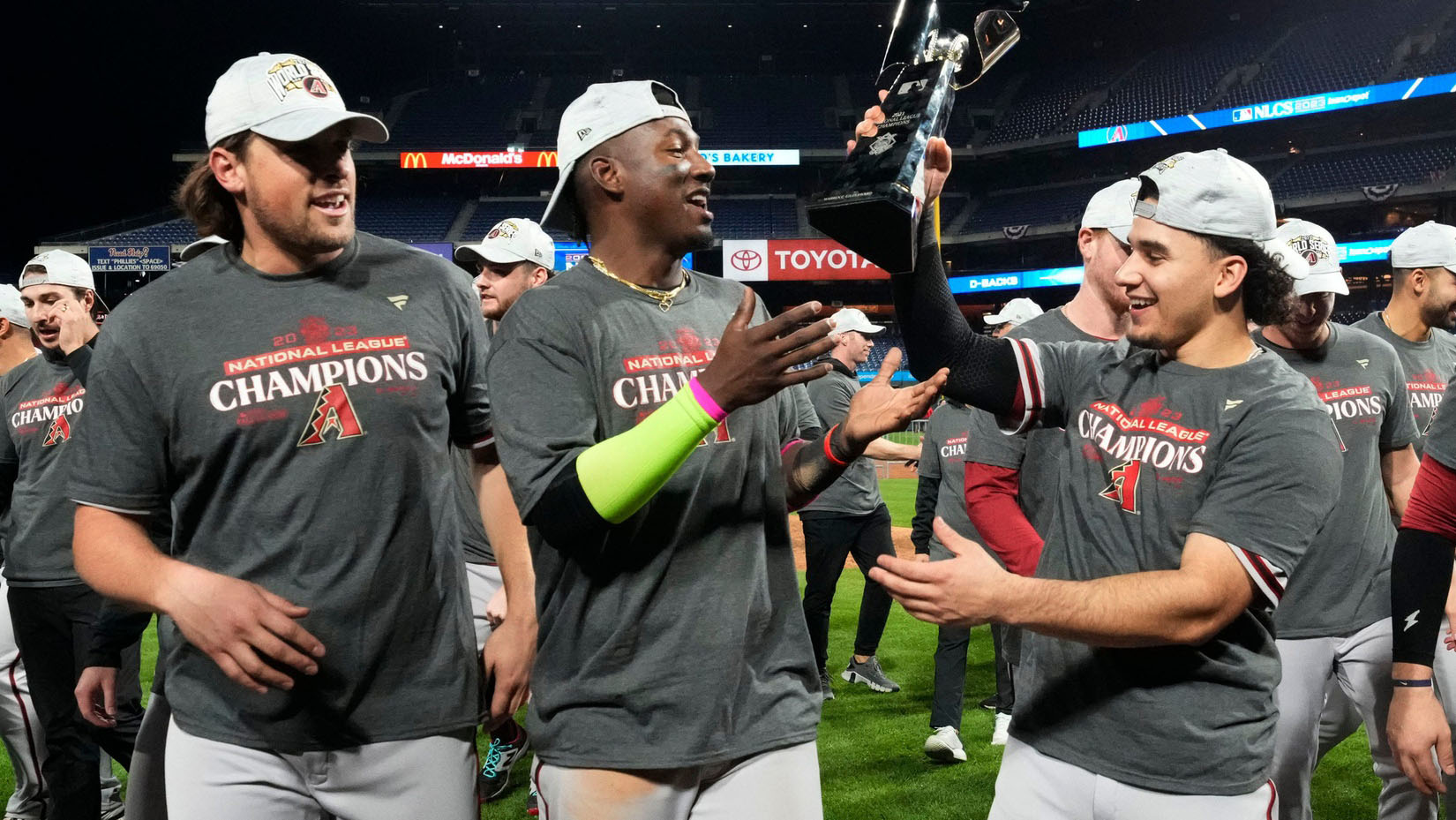 Diamondbacks reliever Kevin Ginkel, shortstop Geraldo Perdomo, and center fielder Alek Thomas celebrate the team's win in Game 7 of the National League Championship Series.