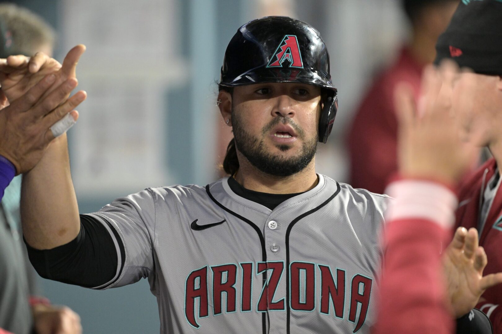 Eugenio Suarez celebrates in the Diamondbacks dugout after scoring against the Los Angeles Dodgers