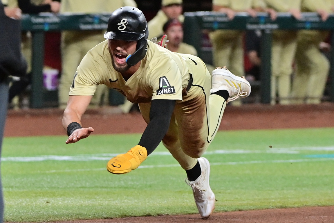 Blaze Alexander dives into home plate, scoring on Kevin Newman's two-run single.