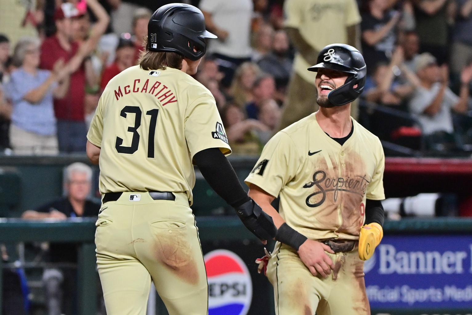 Arizona Diamondbacks outfielder Jake McCarthy and Blaze Alexander celebrate after scoring on Kevin Newman's two-run single against the San Francisco Giants at Chase Field.