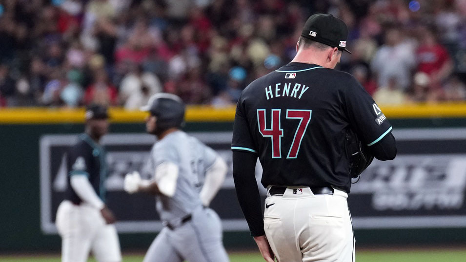 Arizona Diamondbacks left-hander Tommy Henry watches Lenyn Sosa round the bases after hitting a three-run home run.