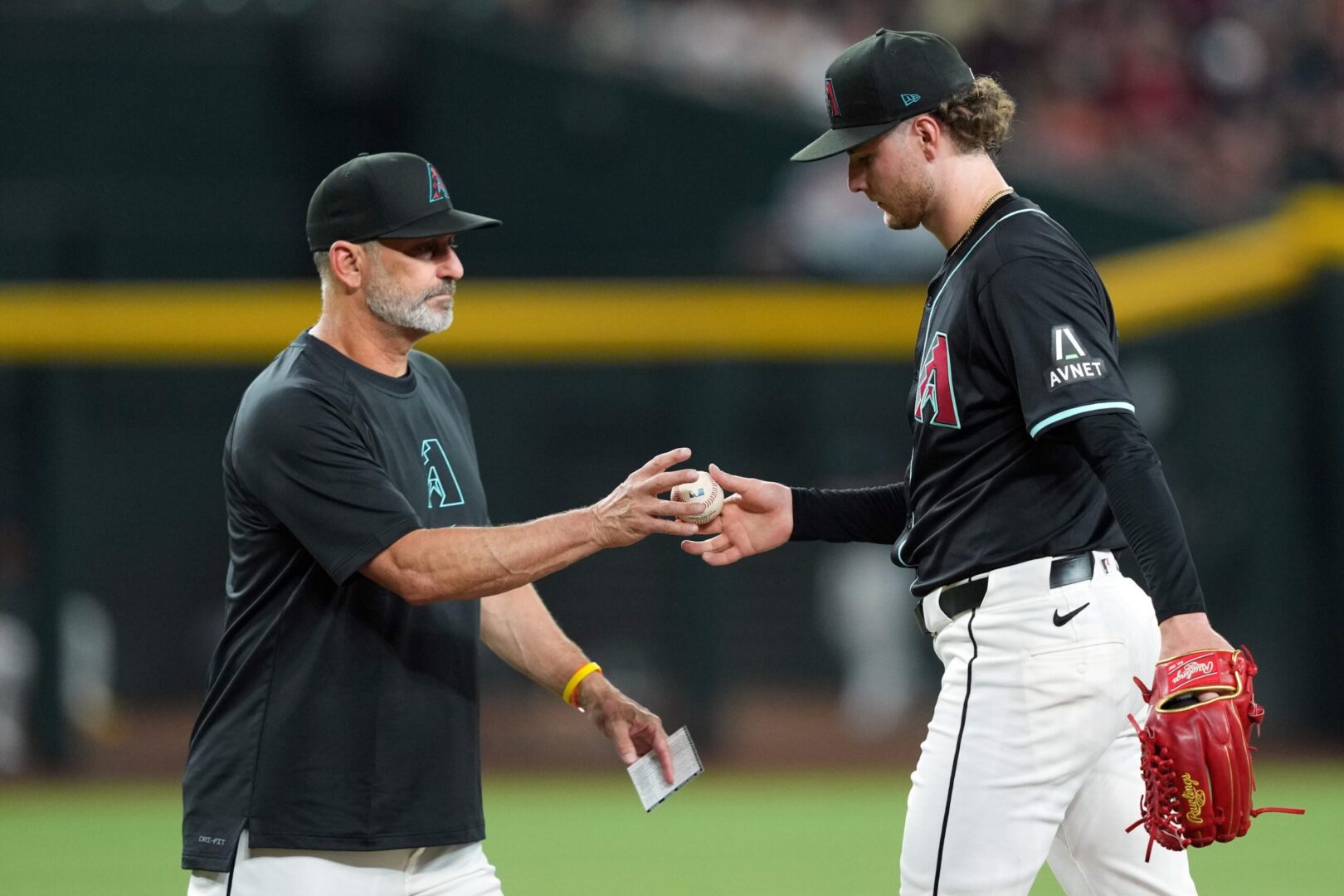 Diamondbacks manager Torey Lovullo takes the baseball from right-hander Ryne Nelson.