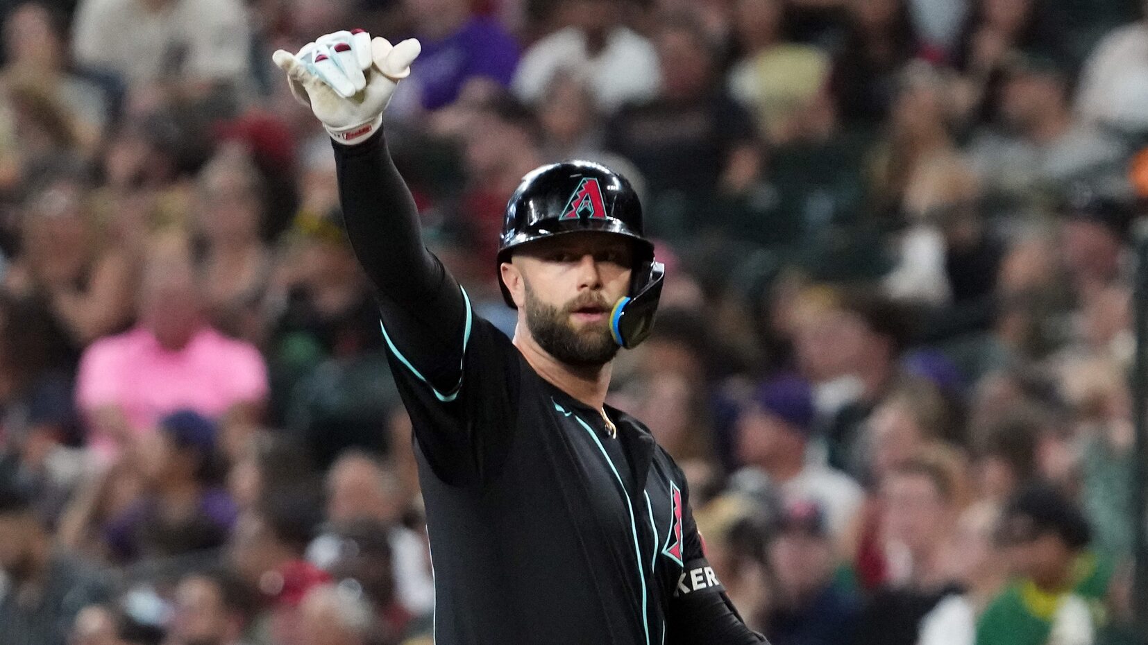 Diamondbacks first baseman Christian Walker gestures to his dugout after hitting an RBI single against the Oakland Athletics at Chase Field.