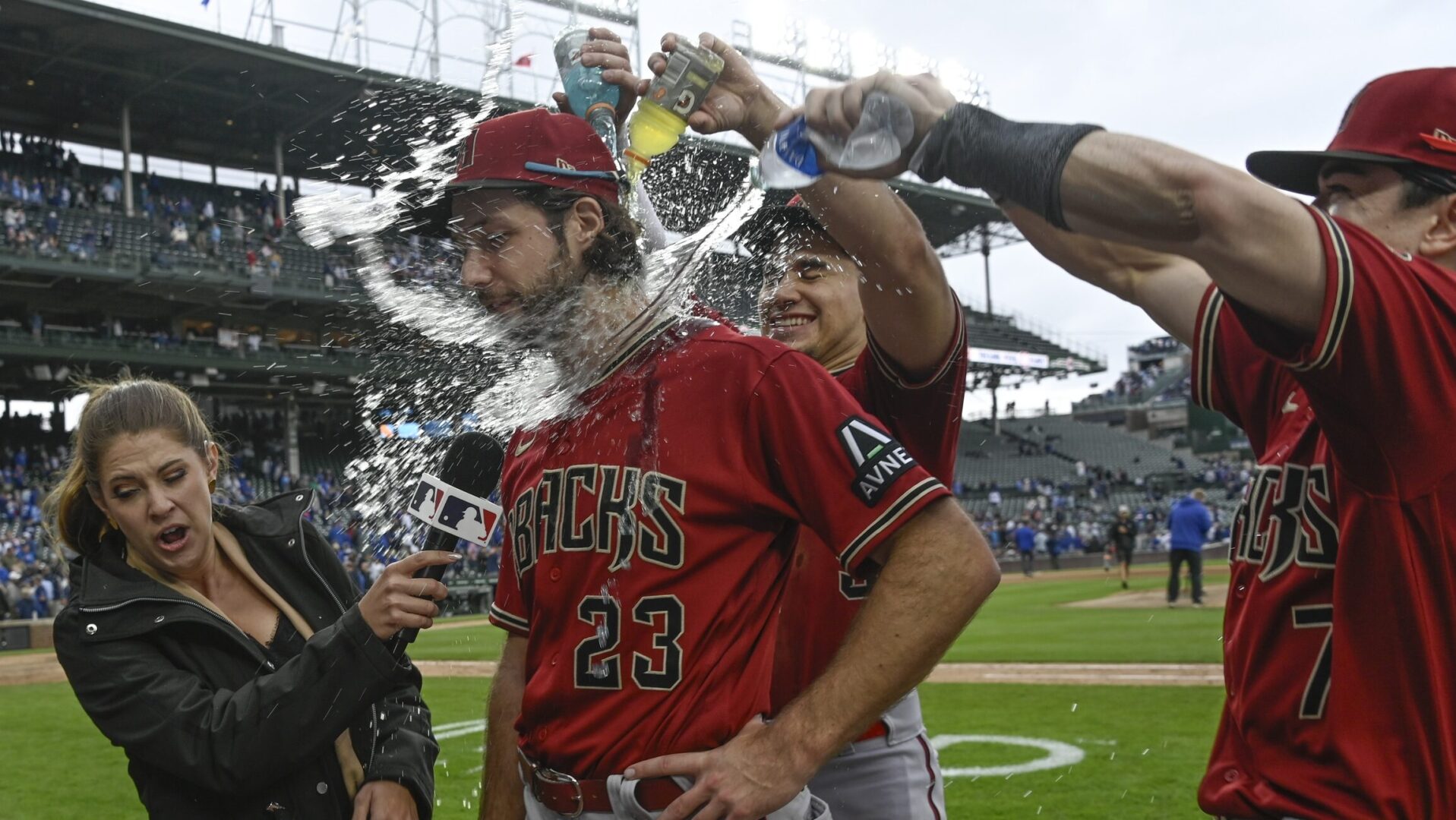 Diamondbacks starting pitcher Zac Gallen has water and Gatorade poured on him by Alek Thomas and Corbin Carroll after shutting out the Cubs at Wrigley Field.