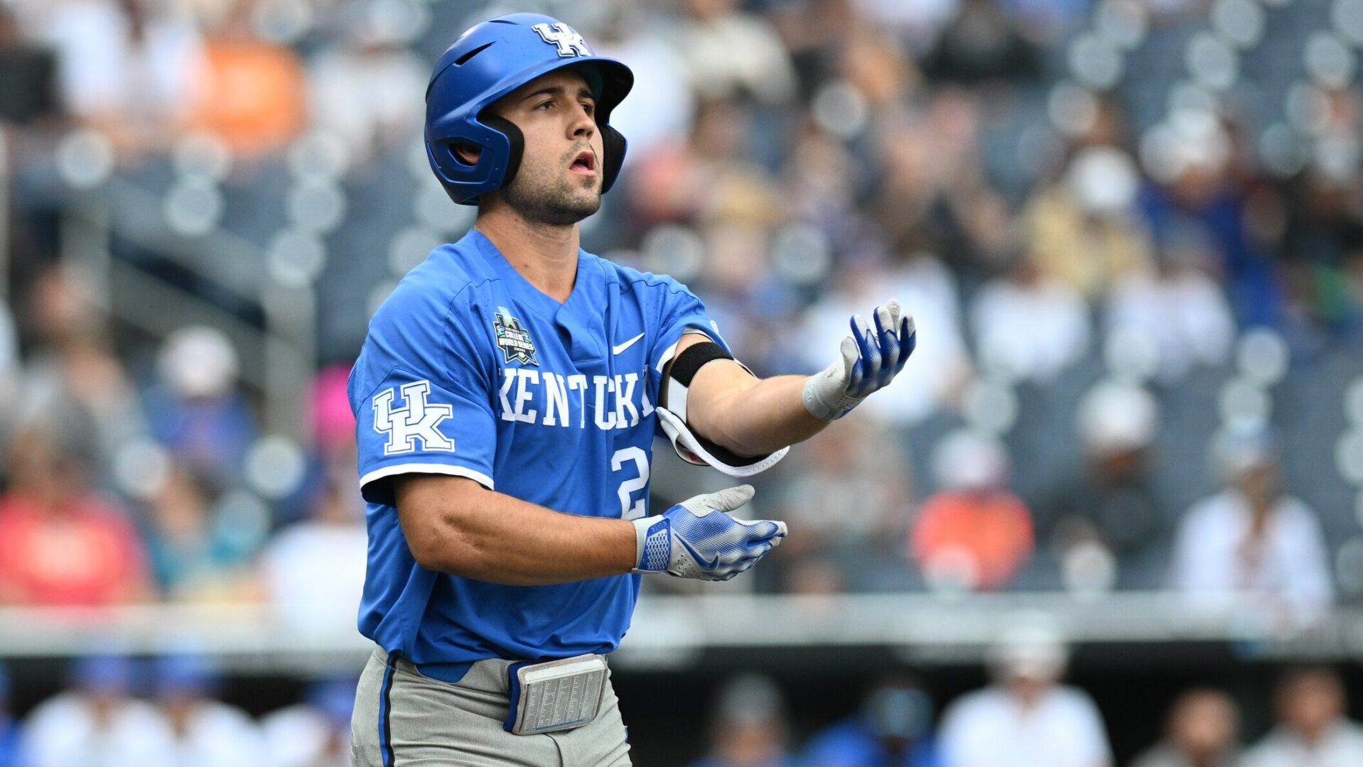 Ryan Waldschmidt removes his elbow guard before taking his base in the College World Series game vs. Florida.