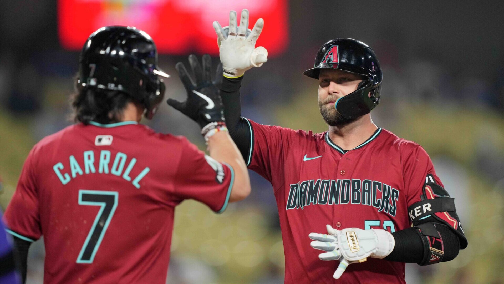 Diamondbacks first baseman Christian Walker celebrates with Corbin Carroll at home plate after hitting a three-run home run against the Dodgers in the 9th inning.