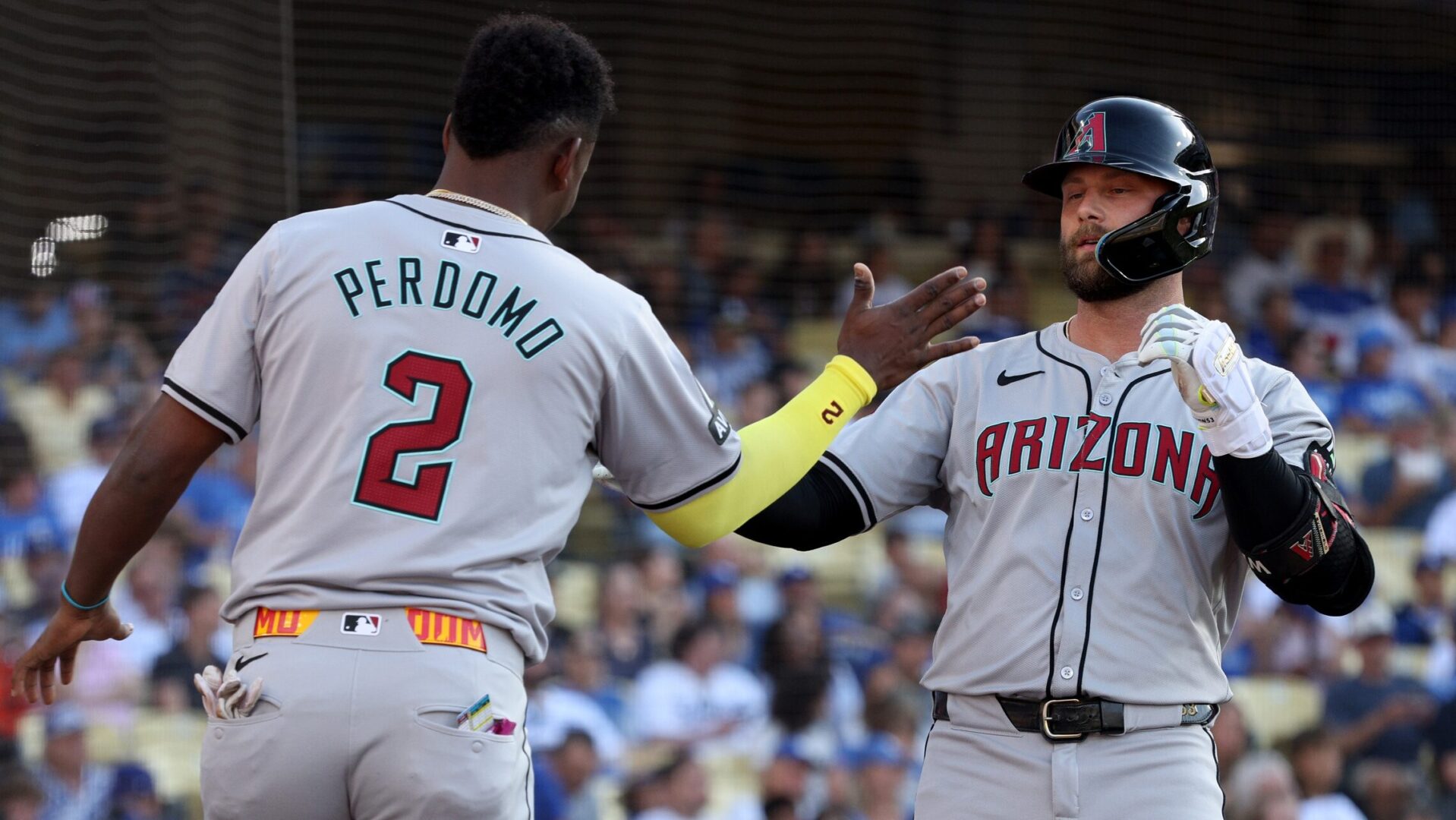 Diamondbacks first baseman Christian Walker celebrates with Geraldo Perdomo after hitting a home run in Dodger Stadium.