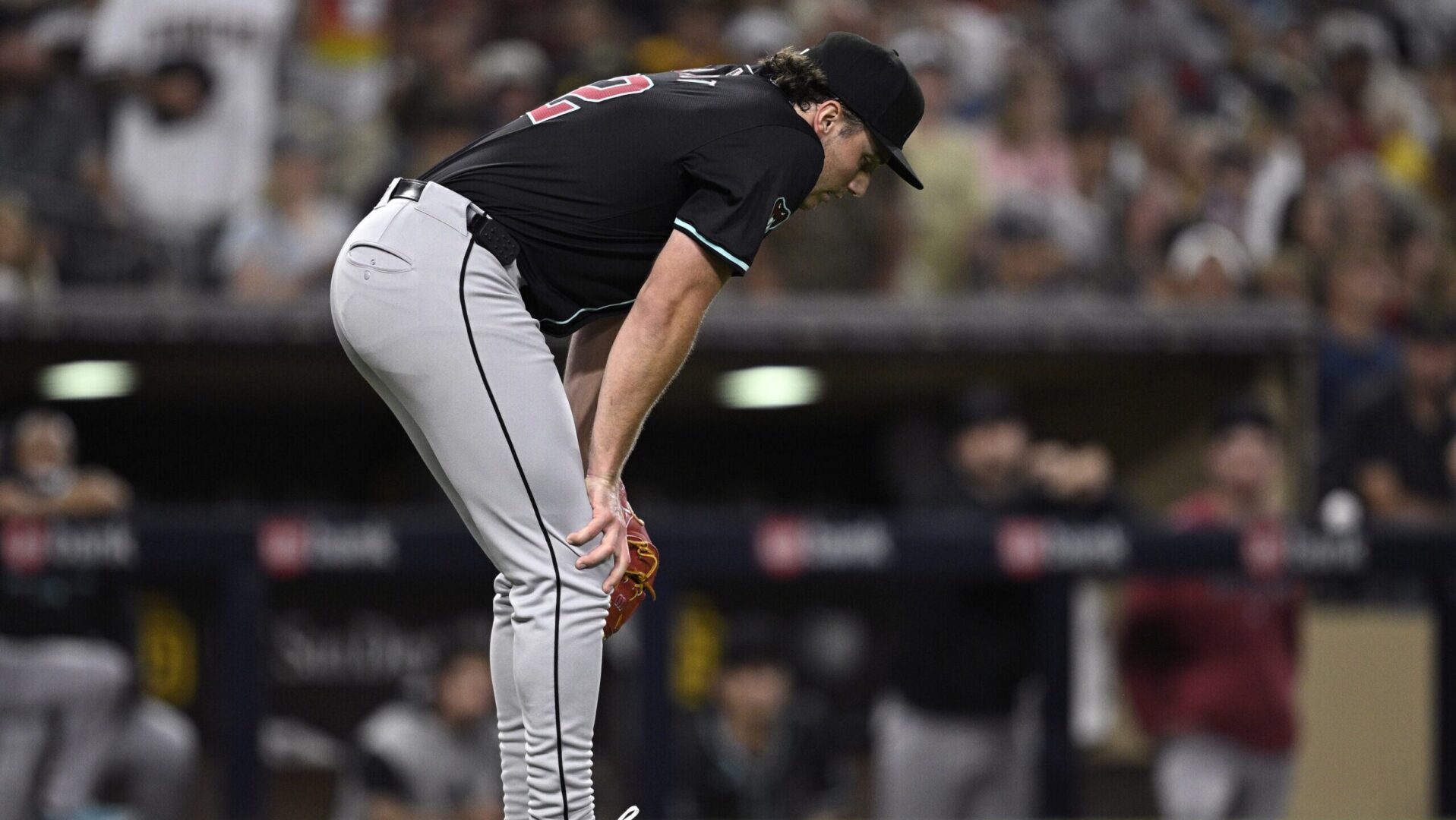 Diamondbacks starting pitcher Brandon Pfaadt stands in front of the mound after getting hit by a line drive.