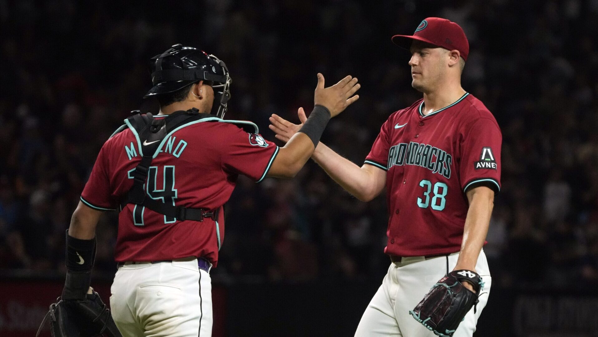 Diamondbacks closer Paul Sewald and catcher Gabriel Moreno celebrate a 1-0 win over the Atlanta Braves.