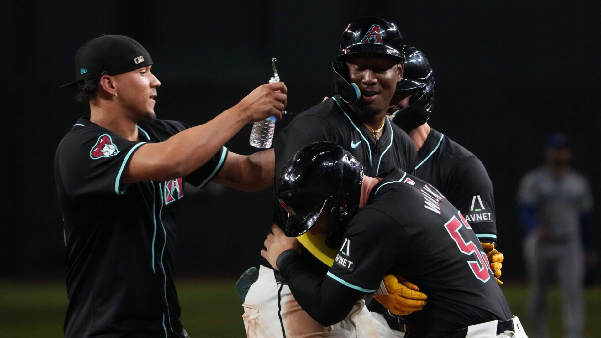 Geraldo Perdomo celebrates with his teammates after hitting a walk-off sacrifice fly to defeat the Toronto Blue Jays 5-4 at Chase Field.