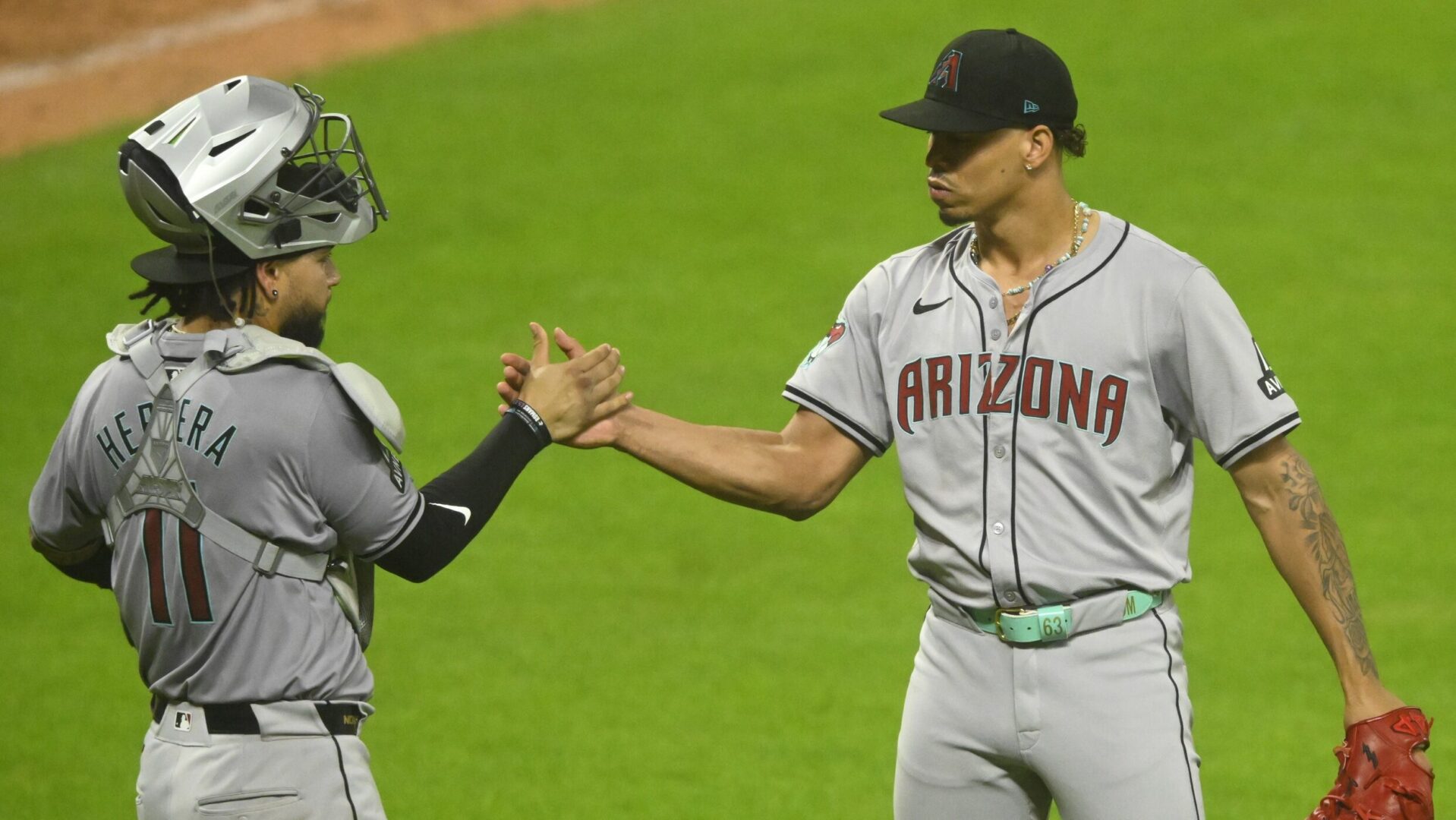 Diamondbacks catcher Jose Herrera and right-handed pitcher Justin Martinez celebrate a 7-6 win over the Cleveland Guardians.