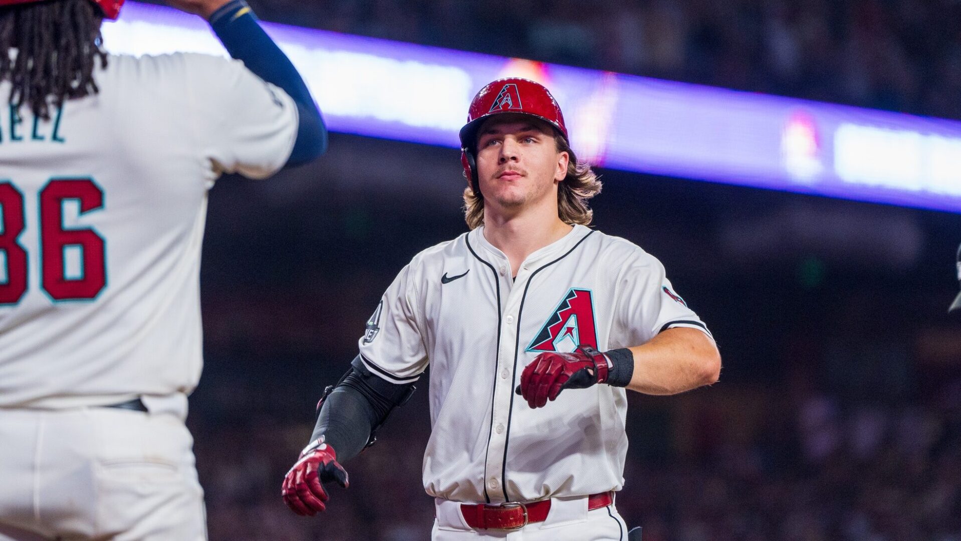 Jake McCarthy celebrates with Josh Bell after hitting his second home run against the Philadelphia Phillies at Chase Field.