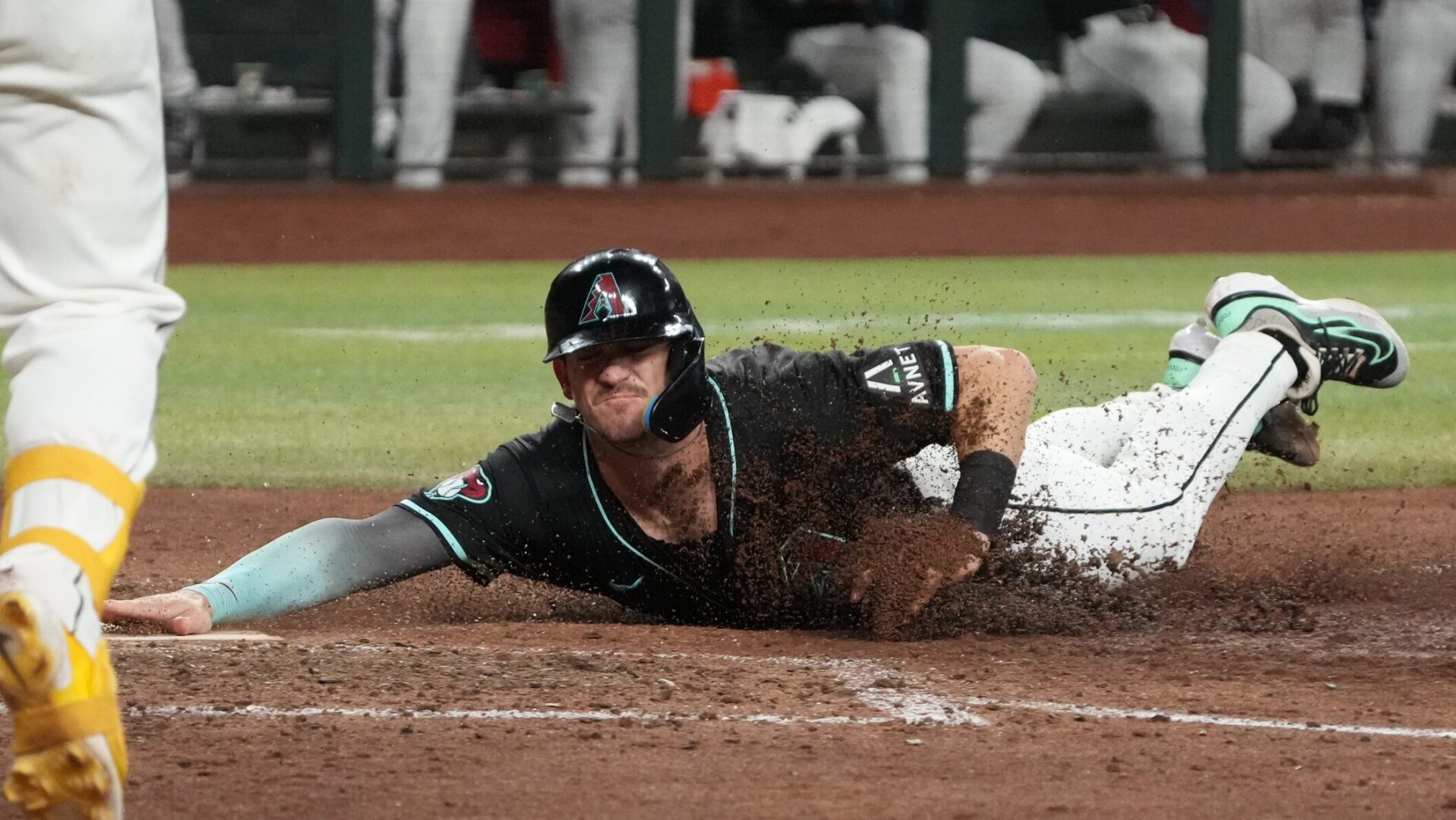 Diamondbacks second baseman Kevin Newman scores the go-ahead run against the Colorado Rockies.