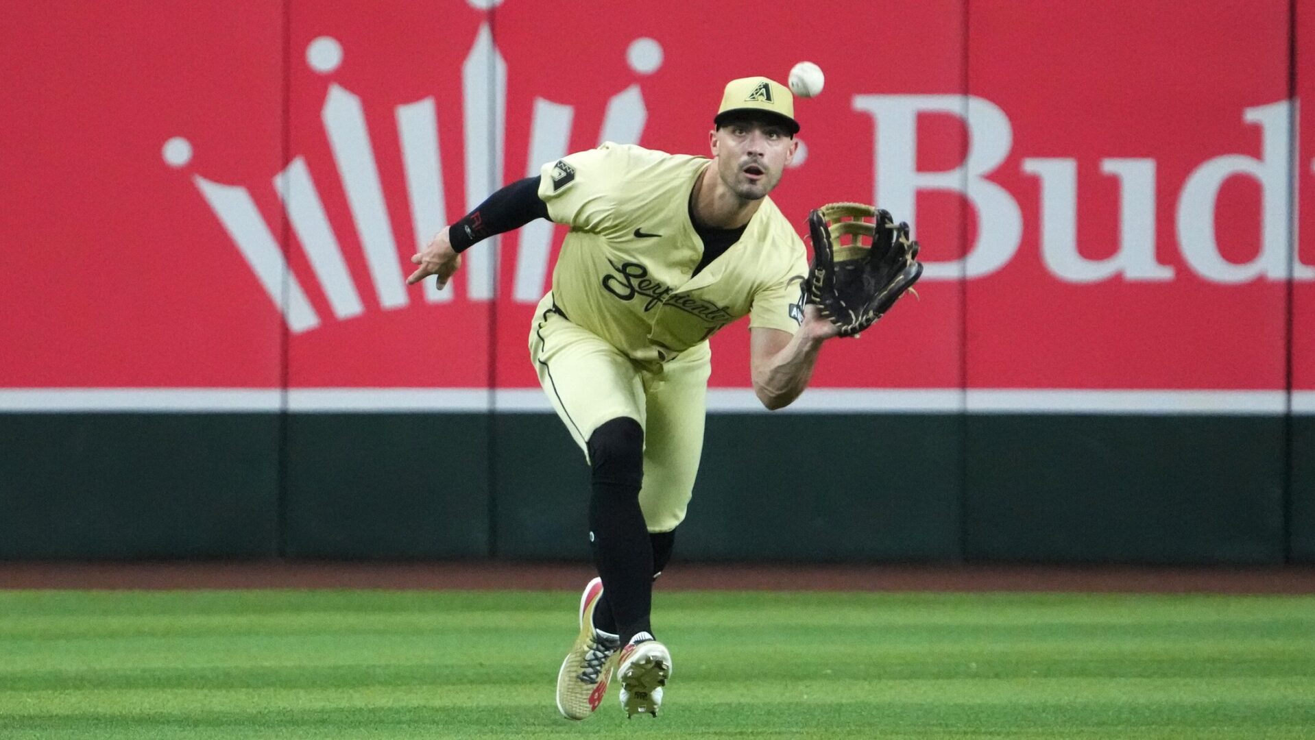 Randal Grichuk closes in on a sinking line drive against the Colorado Rockies.