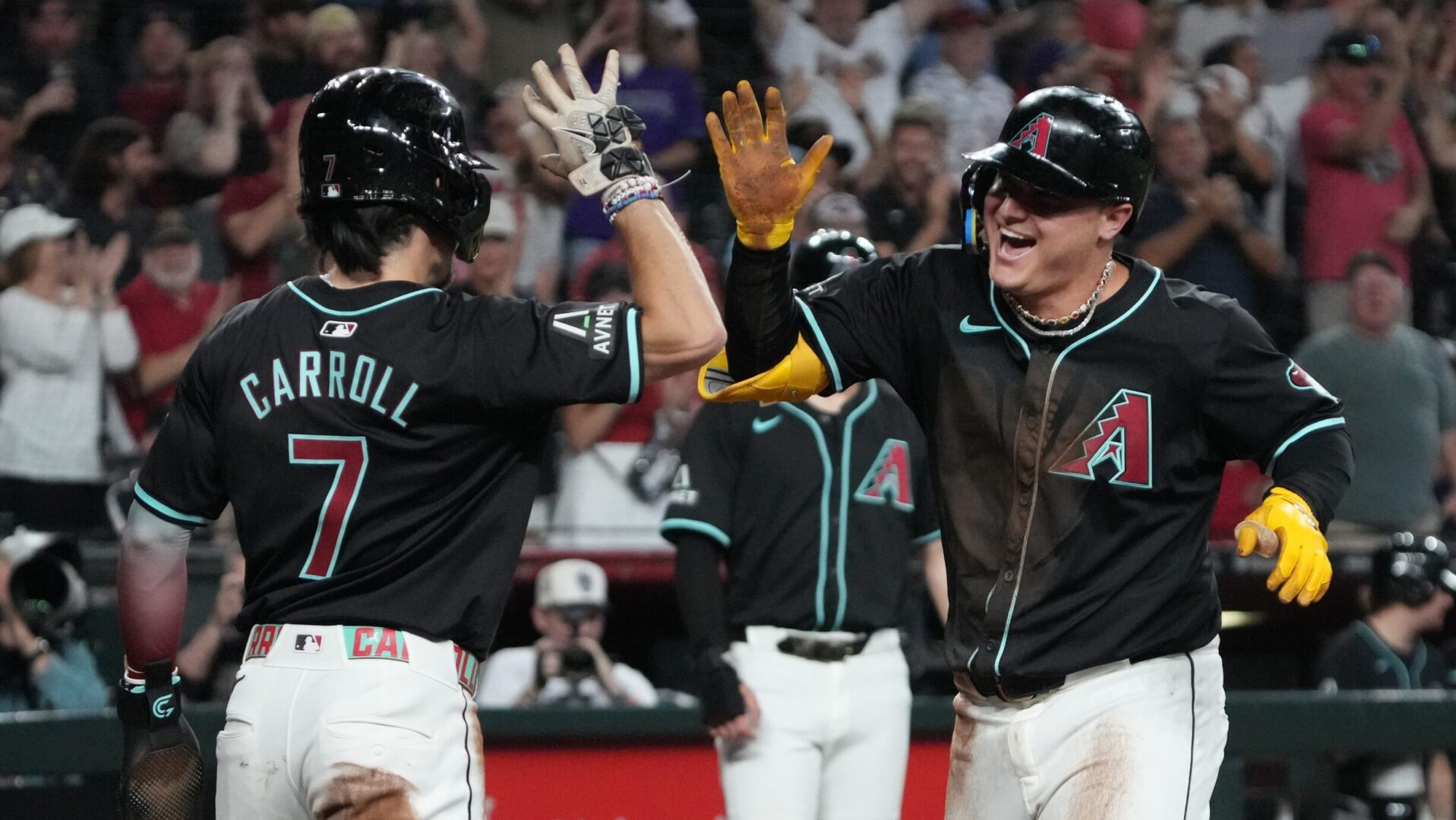 Diamondbacks Joc Pederson and Corbin Carroll celebrate at home plate.