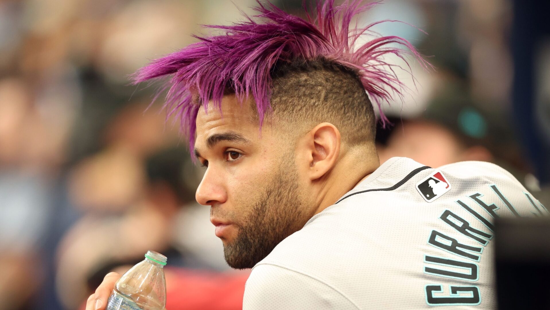 Diamondbacks outfielder Lourdes Gurriel Jr. watches the game from the dugout.