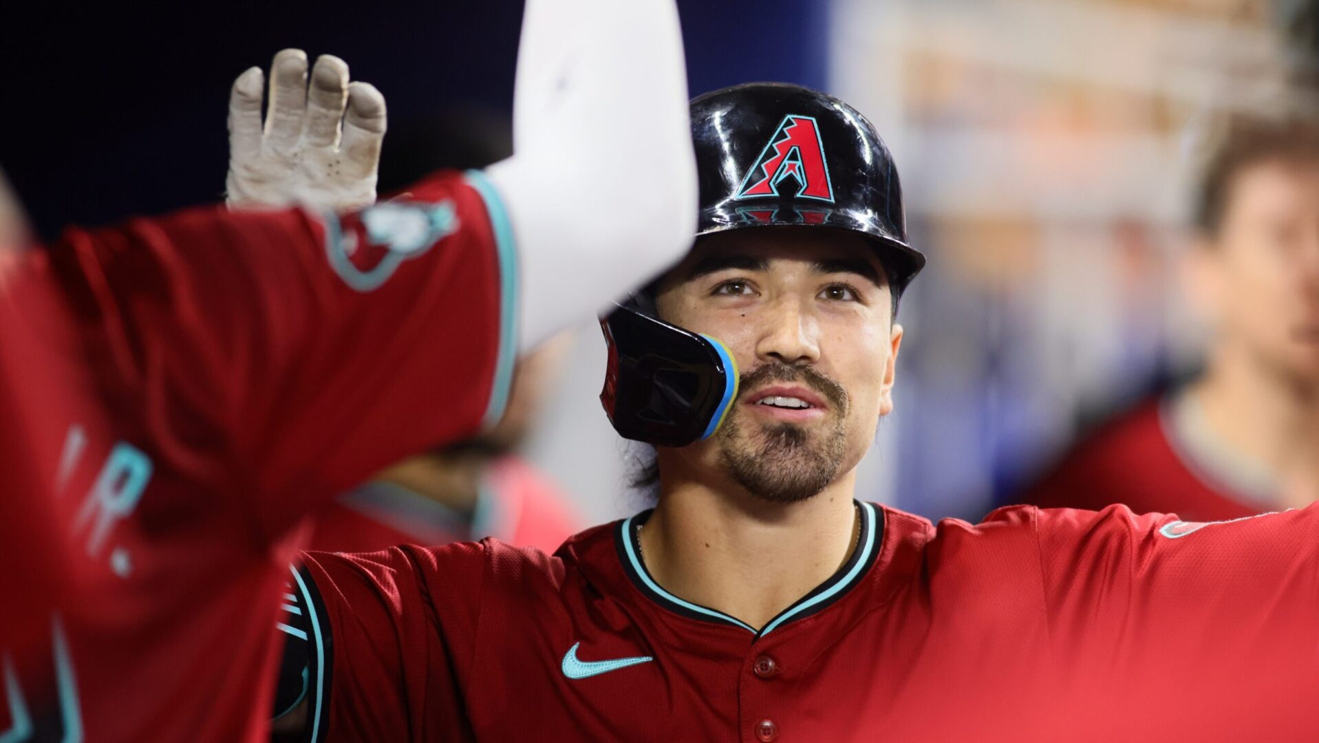 Corbin Carroll celebrates in the dugout after hitting a solo home run against the Miami Marlins at loanDepot Park.