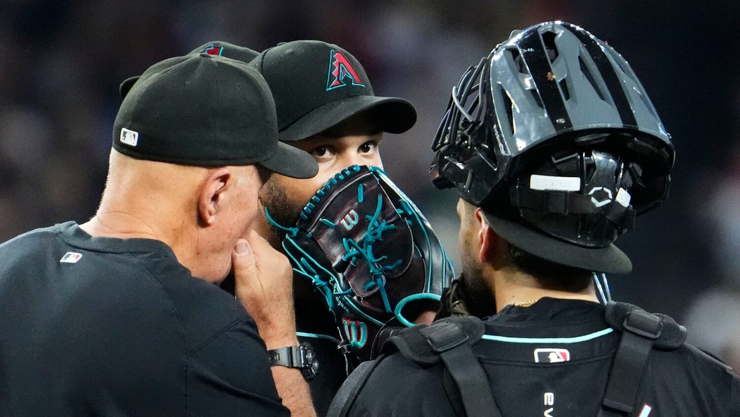 Eduardo Rodriguez talks with Diamondbacks pitching coach Brent Strom during a mound visit.