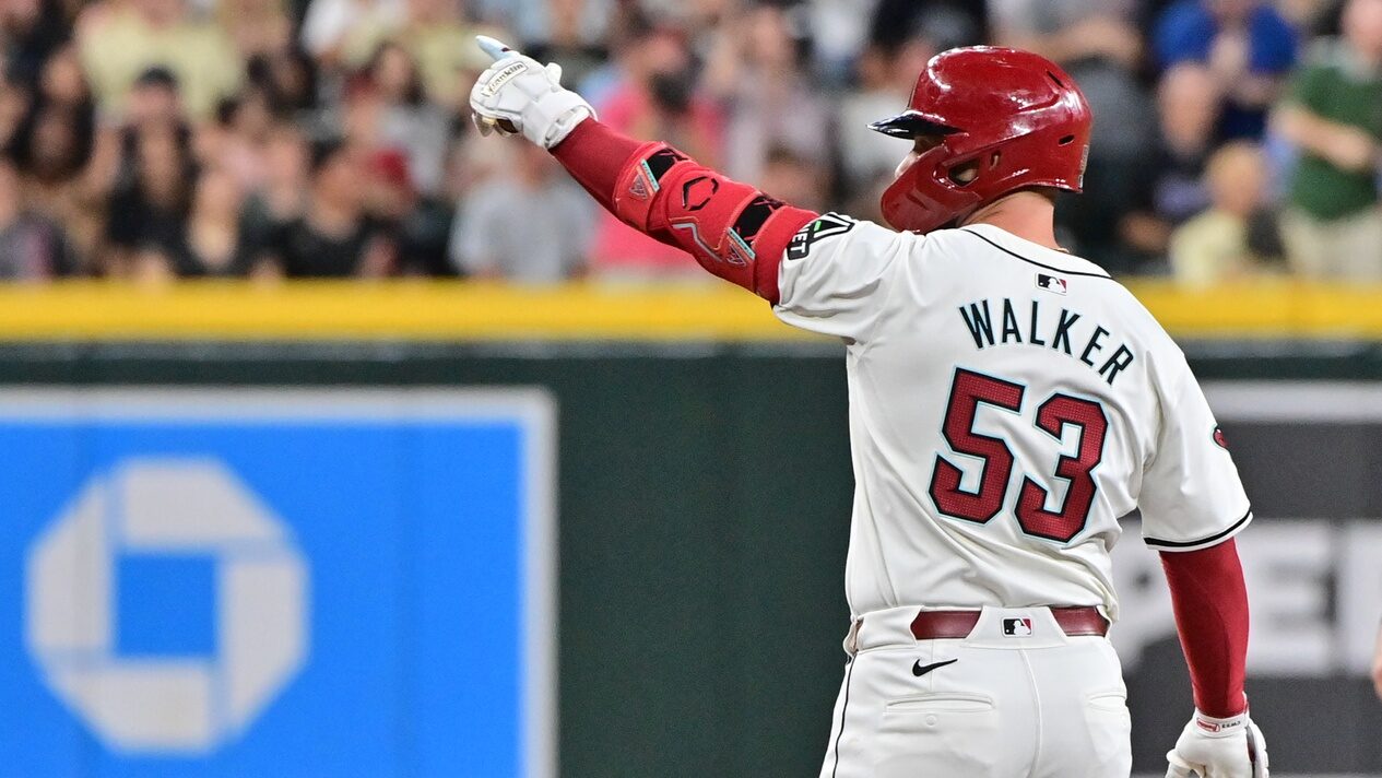 Christian Walker points towards the Diamondbacks bullpen after hitting a double.