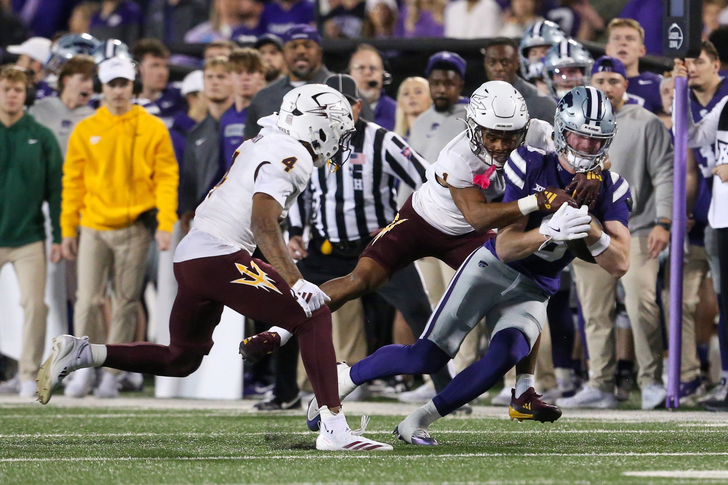 Nov 16, 2024; Manhattan, Kansas, USA; Kansas State Wildcats wide receiver Ty Bowman (8) is tackled by Arizona State Sun Devils defensive back Keith Abney II (1) and defensive back Myles Rowser (4) during the second quarter at Bill Snyder Family Football Stadium. Mandatory Credit: Scott Sewell-Imagn Images