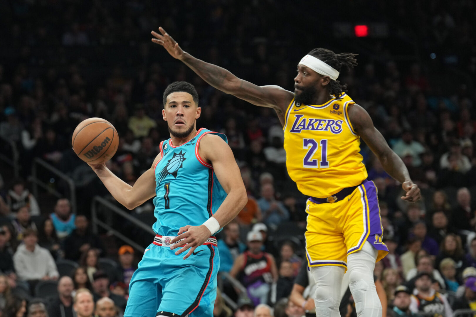 Nov 22, 2022; Phoenix, Arizona, USA; Los Angeles Lakers guard Patrick Beverley (21) guards Phoenix Suns guard Devin Booker (1) during the second half at Footprint Center. Mandatory Credit: Joe Camporeale-Imagn Images