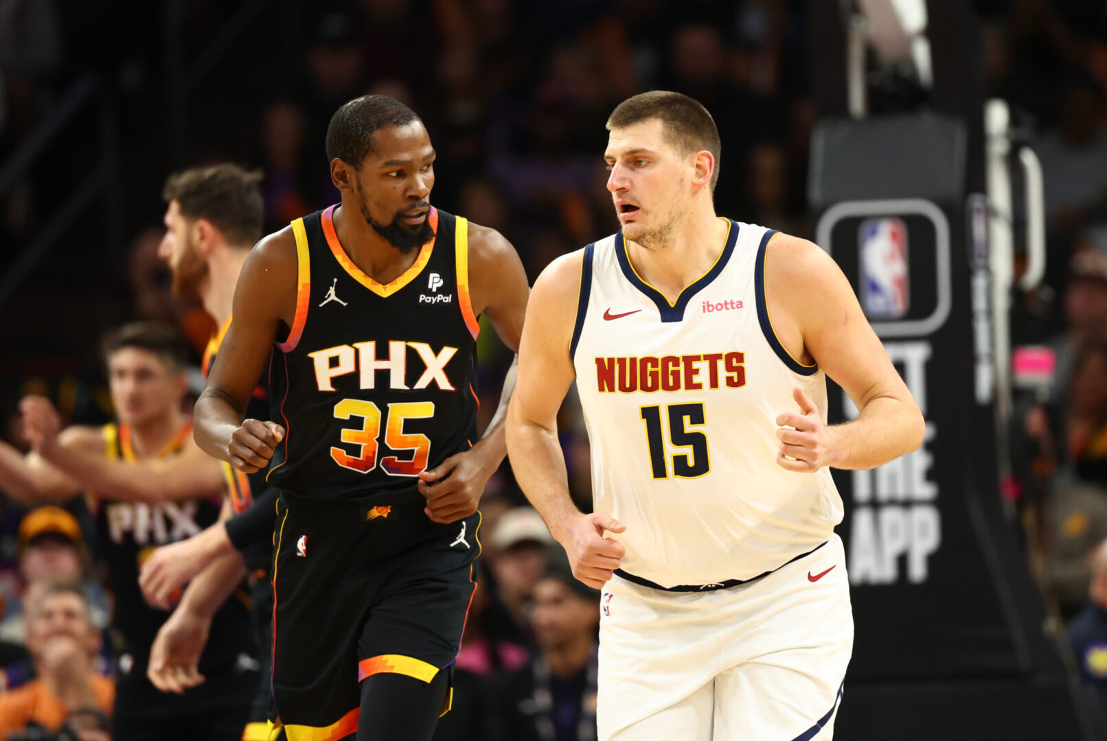 Dec 1, 2023; Phoenix, Arizona, USA; Phoenix Suns forward Kevin Durant (35) against Denver Nuggets center Nikola Jokic (15) in the first half at Footprint Center. Mandatory Credit: Mark J. Rebilas-Imagn Images
