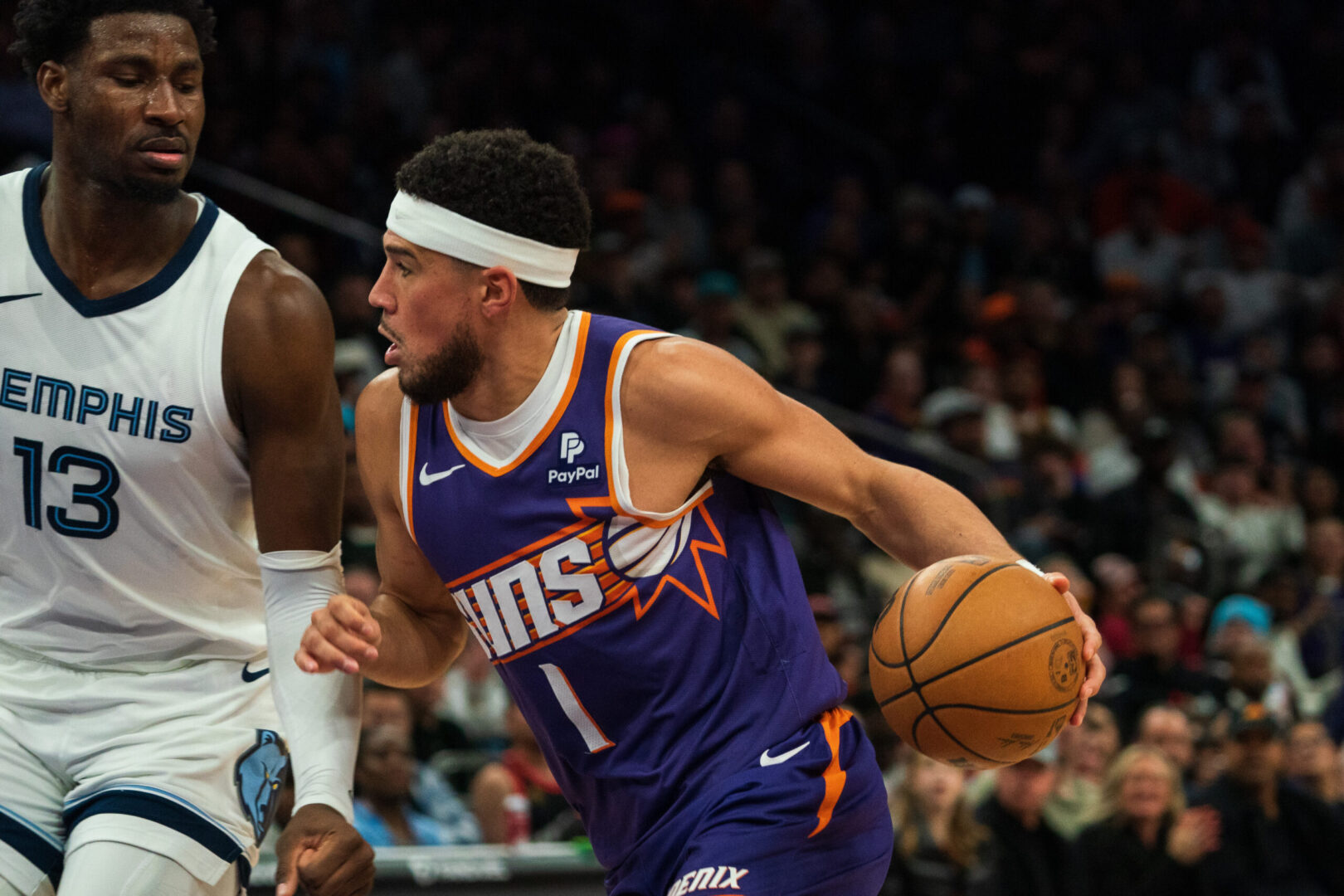 Jan 7, 2024; Phoenix, Arizona, USA; Phoenix Suns guard Devin Booker (1) drives against Memphis Grizzlies forward Jaren Jackson Jr. (13) during the fourth period at Footprint Center. Mandatory Credit: Allan Henry-Imagn Images