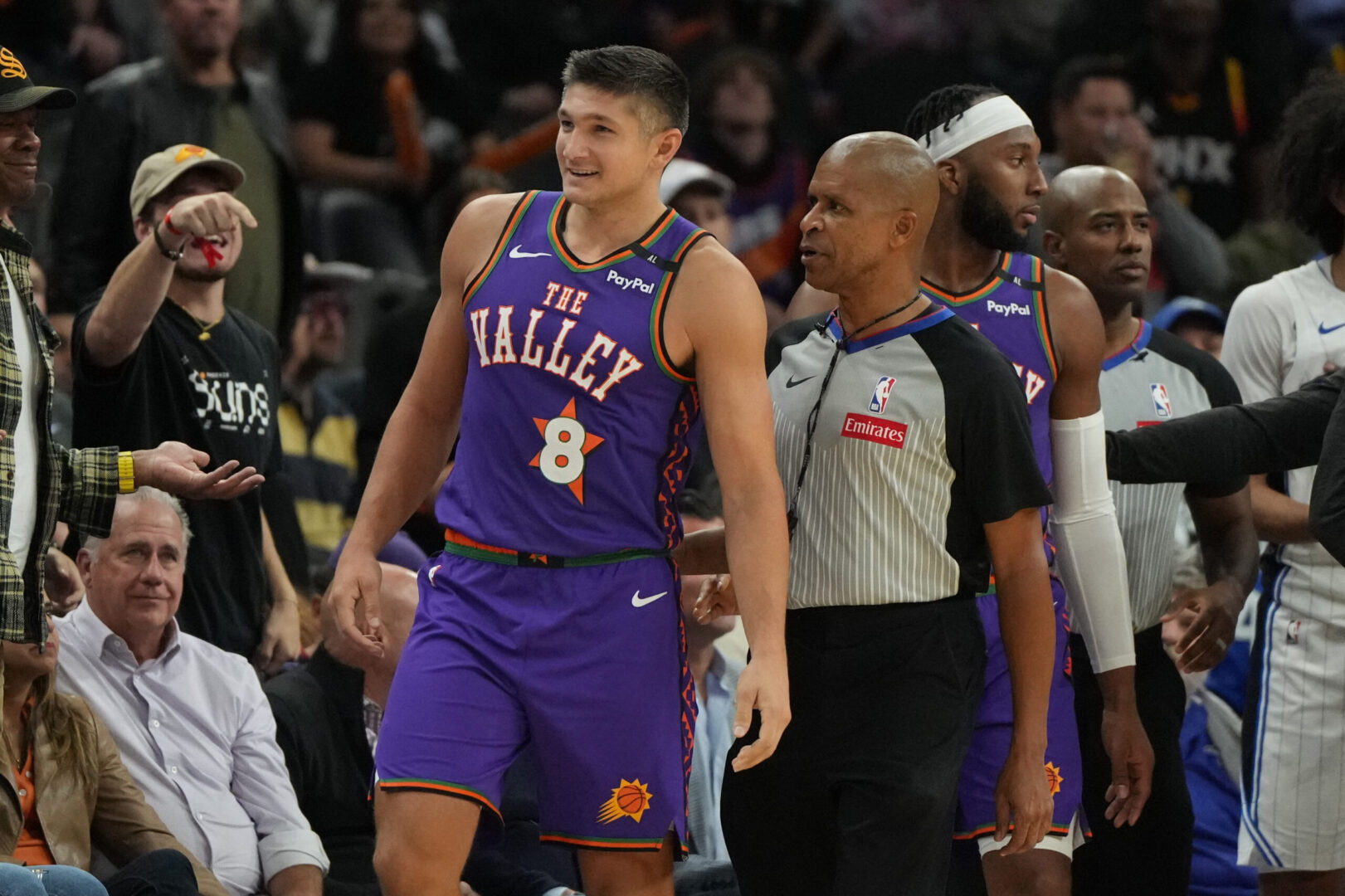 Nov 18, 2024; Phoenix, Arizona, USA; Phoenix Suns guard Grayson Allen (8) gets held back by an official during the second half of an NBA game against the Orlando Magic at Footprint Center. Mandatory Credit: Rick Scuteri-Imagn Images