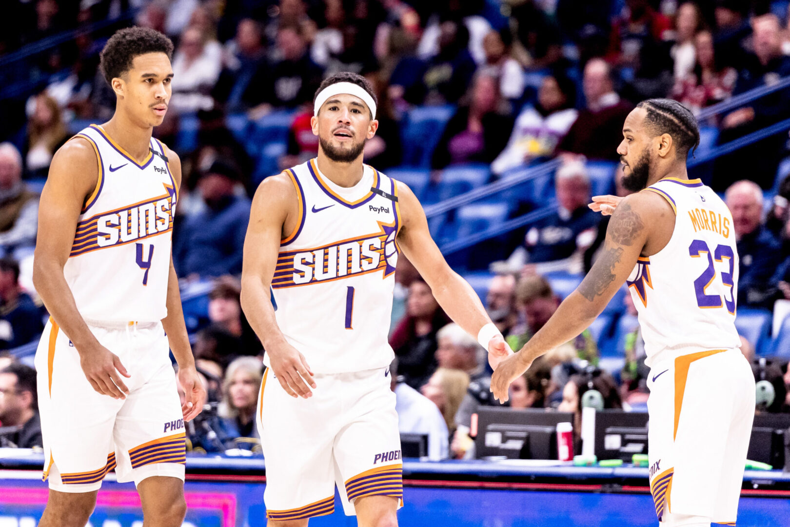 Dec 5, 2024; New Orleans, Louisiana, USA; Phoenix Suns guard Devin Booker (1) slaps hands with guard Monte Morris (23) on a time out against the New Orleans Pelicans during the first half at Smoothie King Center. Mandatory Credit: Stephen Lew-Imagn Images