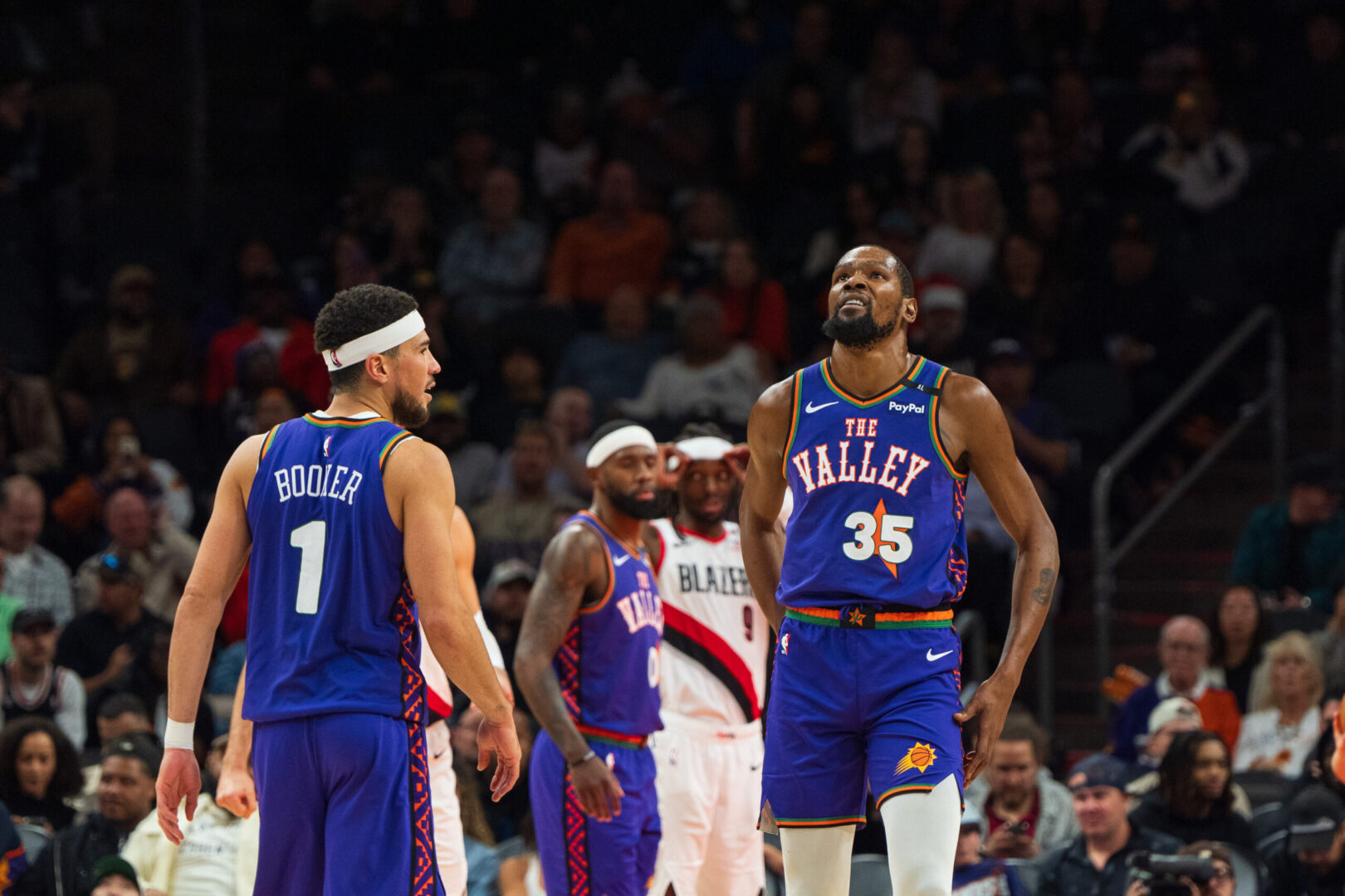 Dec 15, 2024; Phoenix, Arizona, USA; Phoenix Suns guard Devin Booker (1) and forward Kevin Durant (35) react between plays in the second half during a game against the Portland Trail Blazers at Footprint Center. Mandatory Credit: Allan Henry-Imagn Images