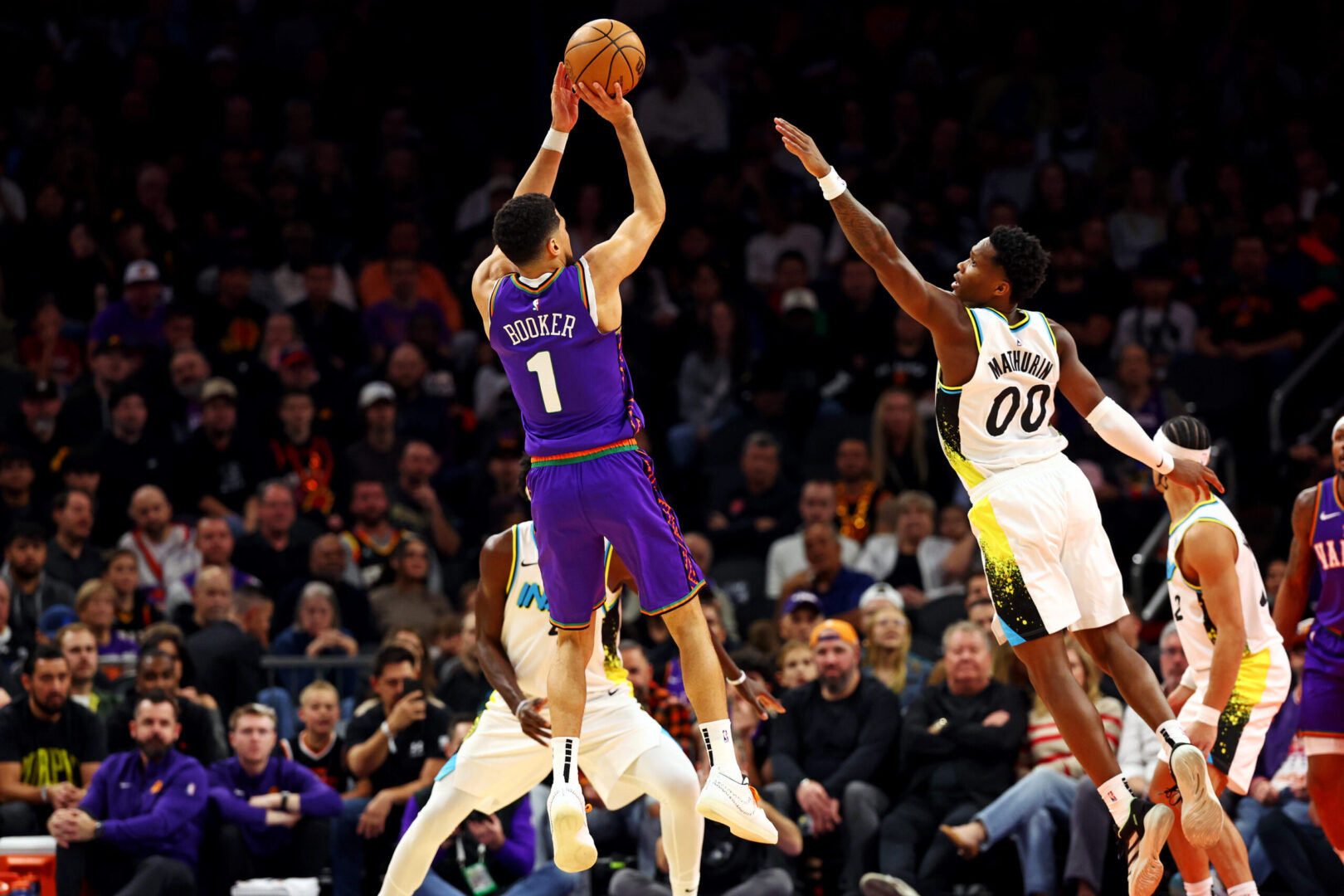 Dec 19, 2024; Phoenix, Arizona, USA; Phoenix Suns guard Devin Booker (1) shoots the ball against Indiana Pacers guard Bennedict Mathurin (00) during the first quarter at Footprint Center. Mandatory Credit: Mark J. Rebilas-Imagn Images