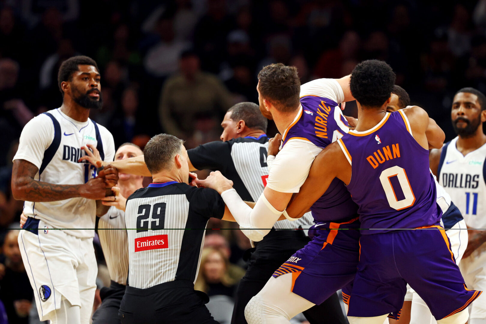 Dec 27, 2024; Phoenix, Arizona, USA; Dallas Mavericks forward Naji Marshall (13) punches Phoenix Suns center Jusuf Nurkic (20) during the third quarter at Footprint Center. Mandatory Credit: Mark J. Rebilas-Imagn Images