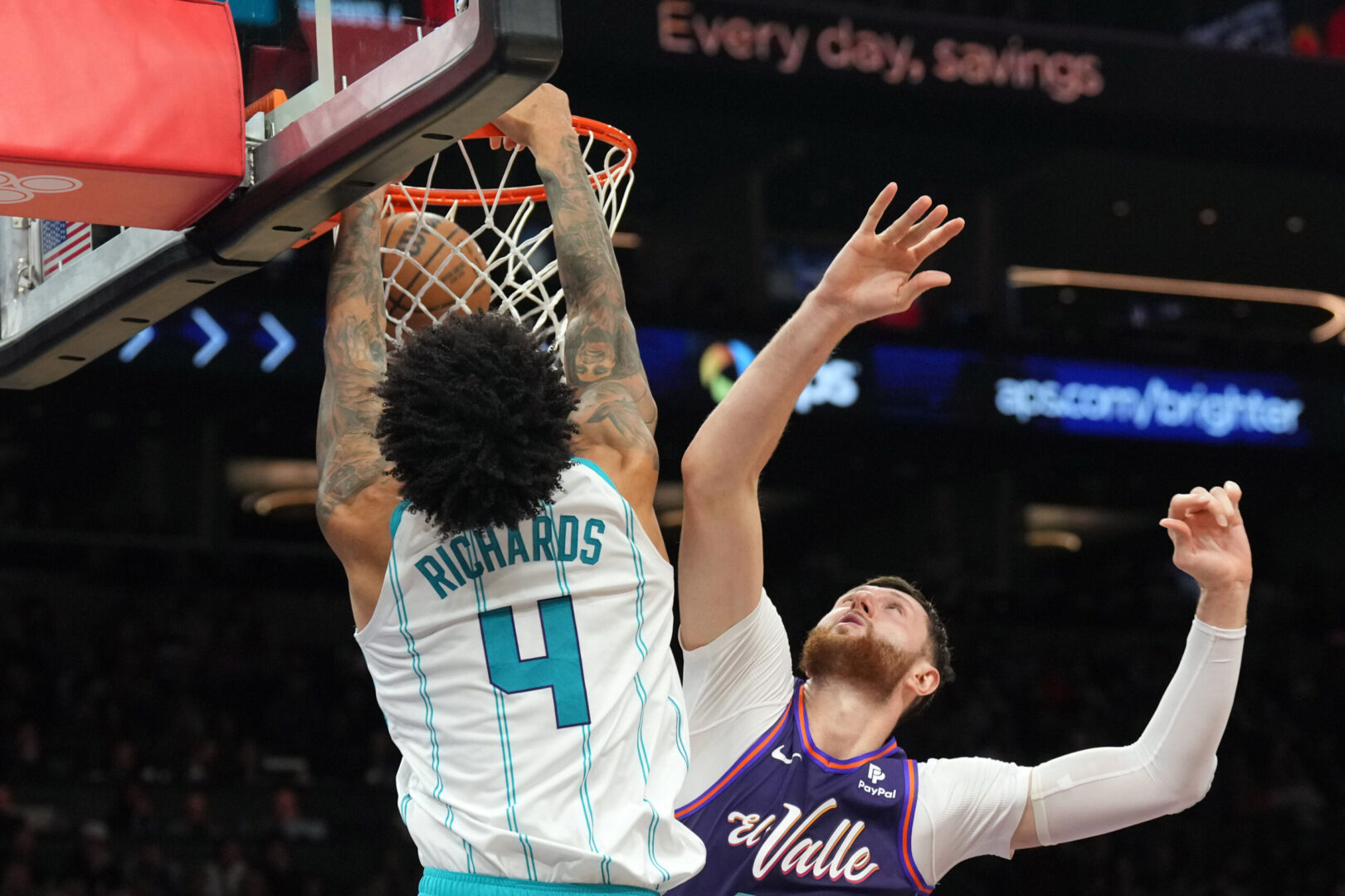 Dec 29, 2023; Phoenix, Arizona, USA; Charlotte Hornets center Nick Richards (4) dunks over Phoenix Suns center Jusuf Nurkic (20) during the first half at Footprint Center. Mandatory Credit: Joe Camporeale-Imagn Images