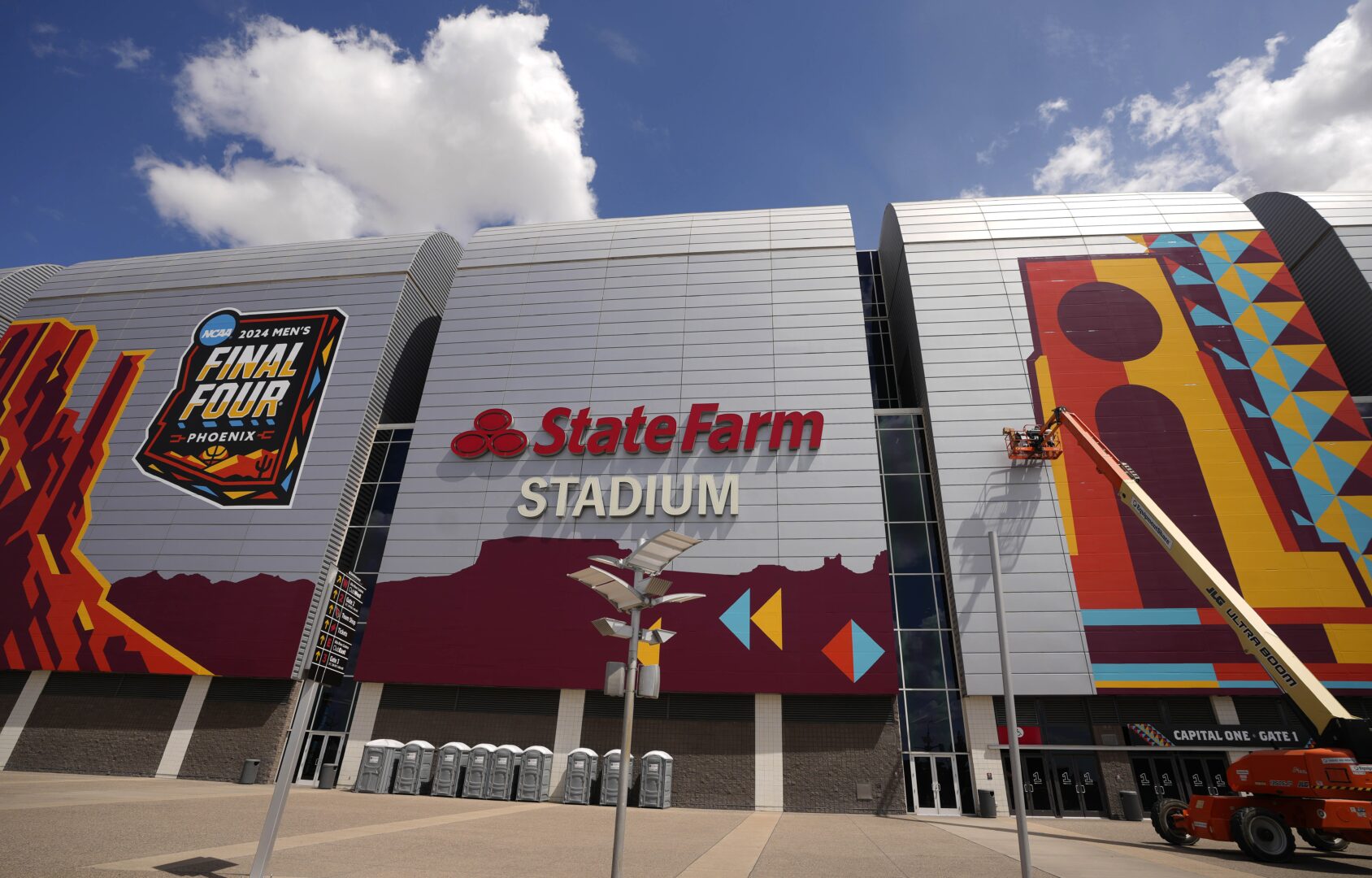 NCAA Final Four decorations go up on the outside of State Farm Stadium in Glendale on March 26, 2024.