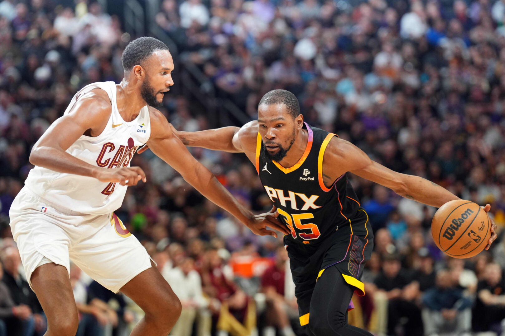 Apr 3, 2024; Phoenix, Arizona, USA; Phoenix Suns forward Kevin Durant (35) dribble against Cleveland Cavaliers forward Evan Mobley (4) during the first half at Footprint Center. Mandatory Credit: Joe Camporeale-Imagn Images