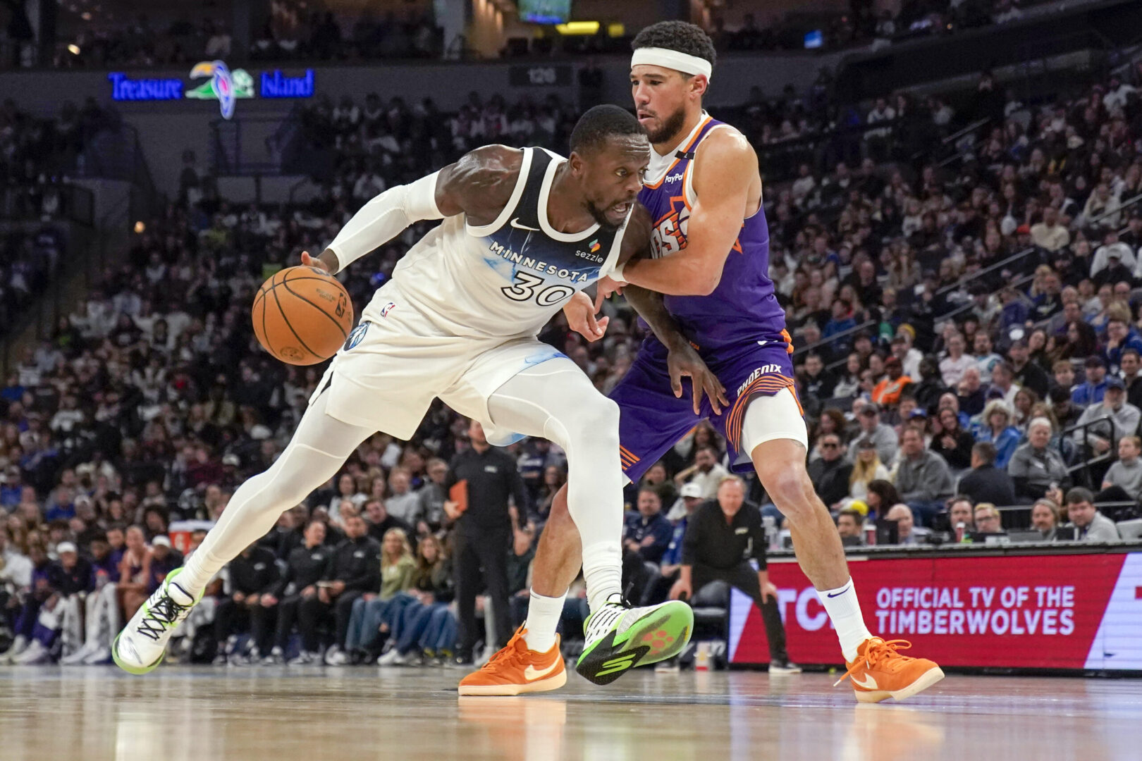 Nov 17, 2024; Minneapolis, Minnesota, USA; Minnesota Timberwolves forward Julius Randle (30) controls the ball as Phoenix Suns guard Devin Booker (1) defends during the third quarter at Target Center. Mandatory Credit: Nick Wosika-Imagn Images