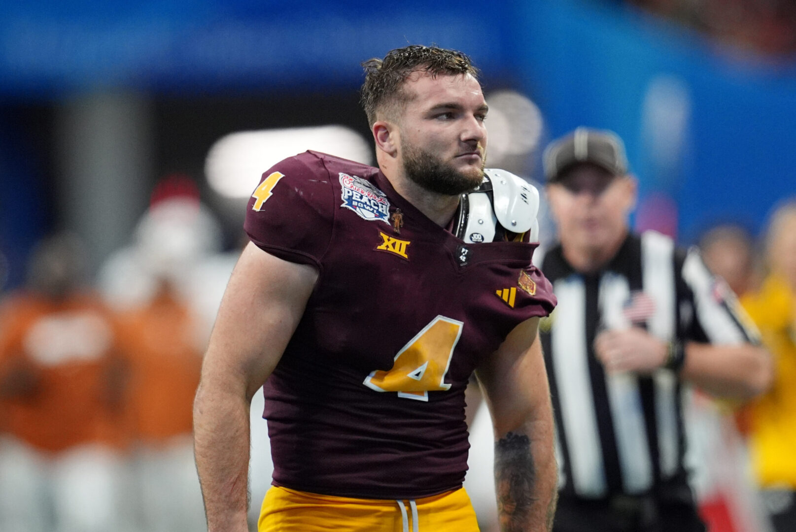 Jan 1, 2025; Atlanta, GA, USA; Arizona State Sun Devils running back Cam Skattebo (4) reacts after losing his helmet while being tackled by Texas Longhorns defensive back Michael Taaffe (16) during the second half of the Peach Bowl at Mercedes-Benz Stadium. Mandatory Credit: Dale Zanine-Imagn Images
