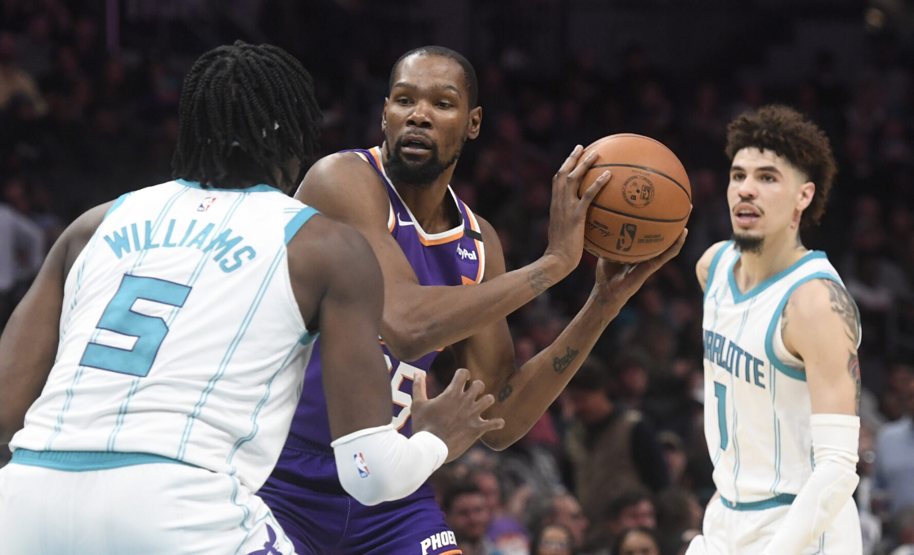 Jan 7, 2025; Charlotte, North Carolina, USA; Phoenix Suns forward Kevin Durant (35) looks top shoot past Charlotte Hornets center Mark Williams (5) during the second half at the Spectrum Center. Mandatory Credit: Sam Sharpe-Imagn Images