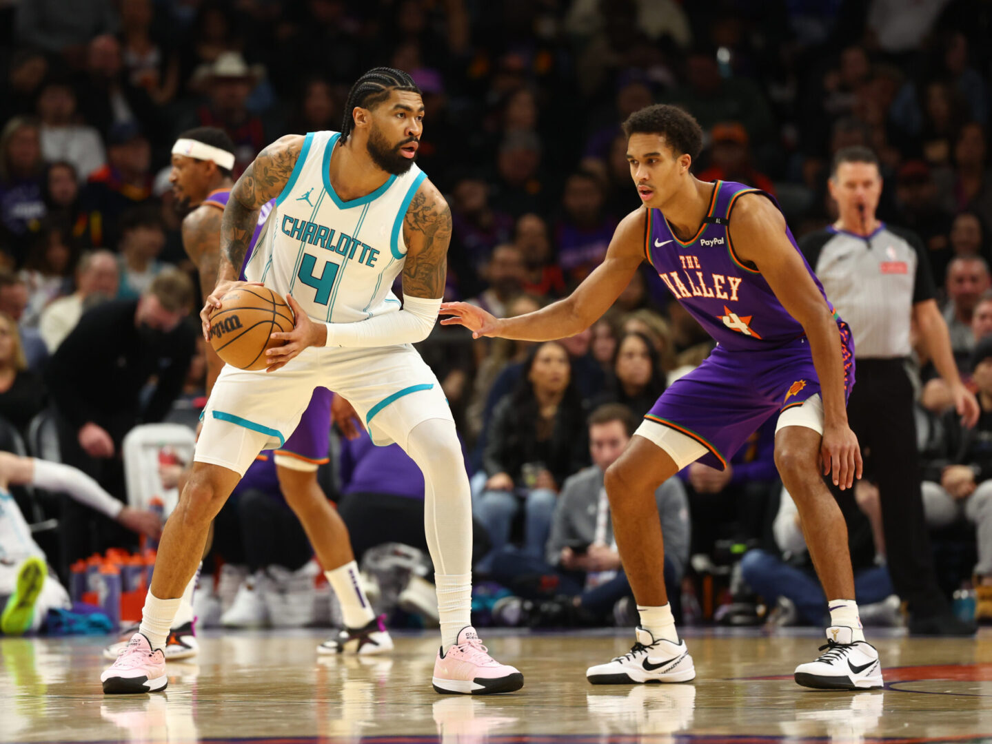 Jan 12, 2025; Phoenix, Arizona, USA; Charlotte Hornets center Nick Richards (left) against Phoenix Suns center Oso Ighodaro at Footprint Center. Mandatory Credit: Mark J. Rebilas-Imagn Images