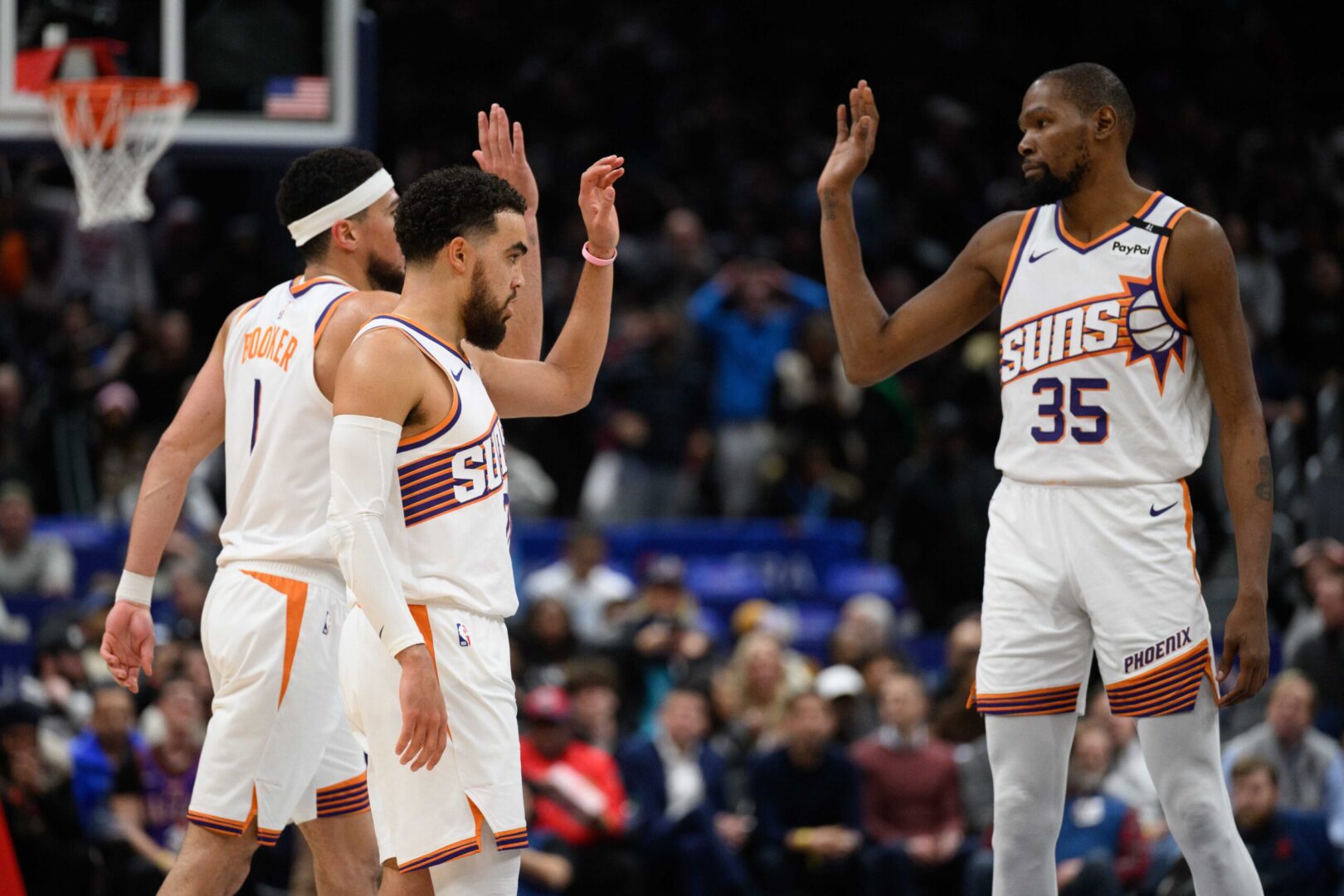 Jan 16, 2025; Washington, District of Columbia, USA; Phoenix Suns guard Tyus Jones (21), guard Devin Booker (1), and forward Kevin Durant (35) celebrate during the fourth quarter against the Washington Wizards at Capital One Arena. Mandatory Credit: Reggie Hildred-Imagn Images