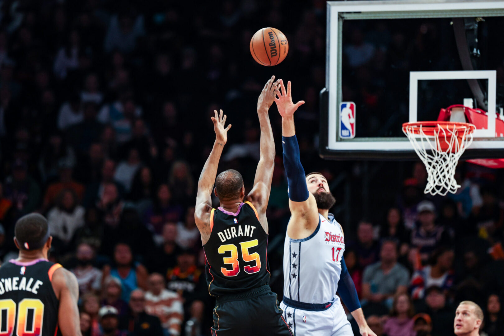 Jan 25, 2025; Phoenix, Arizona, USA; Phoenix Suns forward Kevin Durant (35) shoots a three point shot over Washington Wizards center Jonas Valanciunas (17) during the third quarter at Footprint Center. Mandatory Credit: Aryanna Frank-Imagn Images