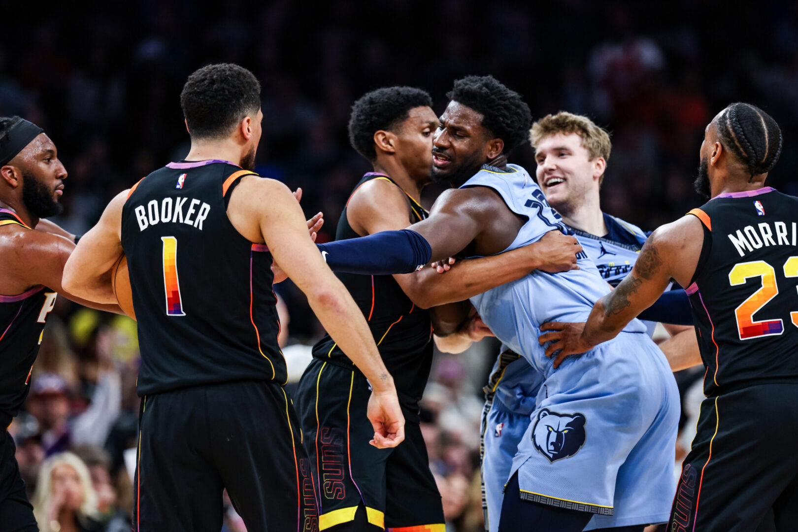 Dec 31, 2024; Phoenix, Arizona, USA; Phoenix Suns guard Devin Booker (1) and forward Ryan Dunn and Memphis Grizzlies guard Cam Spencer (24) and forward-center Jaren Jackson Jr. (13) react during the fourth quarter of the game at Footprint Center. Mandatory Credit: Aryanna Frank-Imagn Images