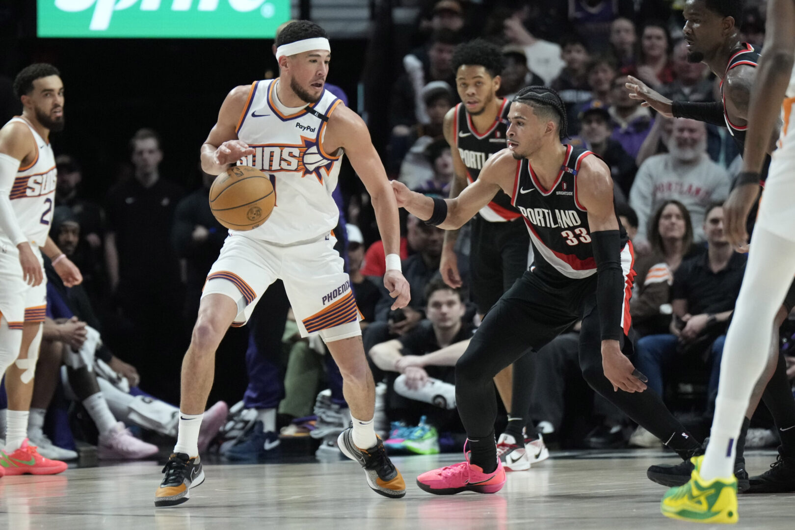 Feb 1, 2025; Portland, Oregon, USA; Phoenix Suns shooting guard Devin Booker (1) handles the ball against Portland Trail Blazers forward Toumani Camara (33) during the second half at Moda Center. Mandatory Credit: Soobum Im-Imagn Images