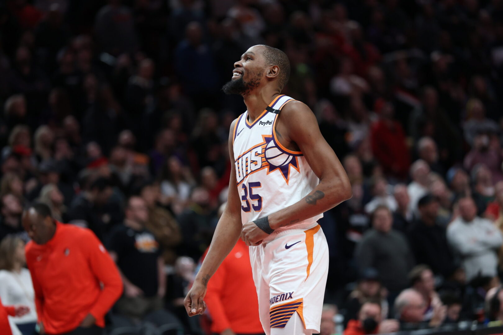 Feb 3, 2025; Portland, Oregon, USA; Phoenix Suns forward Kevin Durant (35) laughs as he watches a replay of his teammate Suns’ guard Devin Booker (1) being fouled by Portland Trail Blazers forward Deni Avdija (8) in overtime at Moda Center. Mandatory Credit: Jaime Valdez-Imagn Images