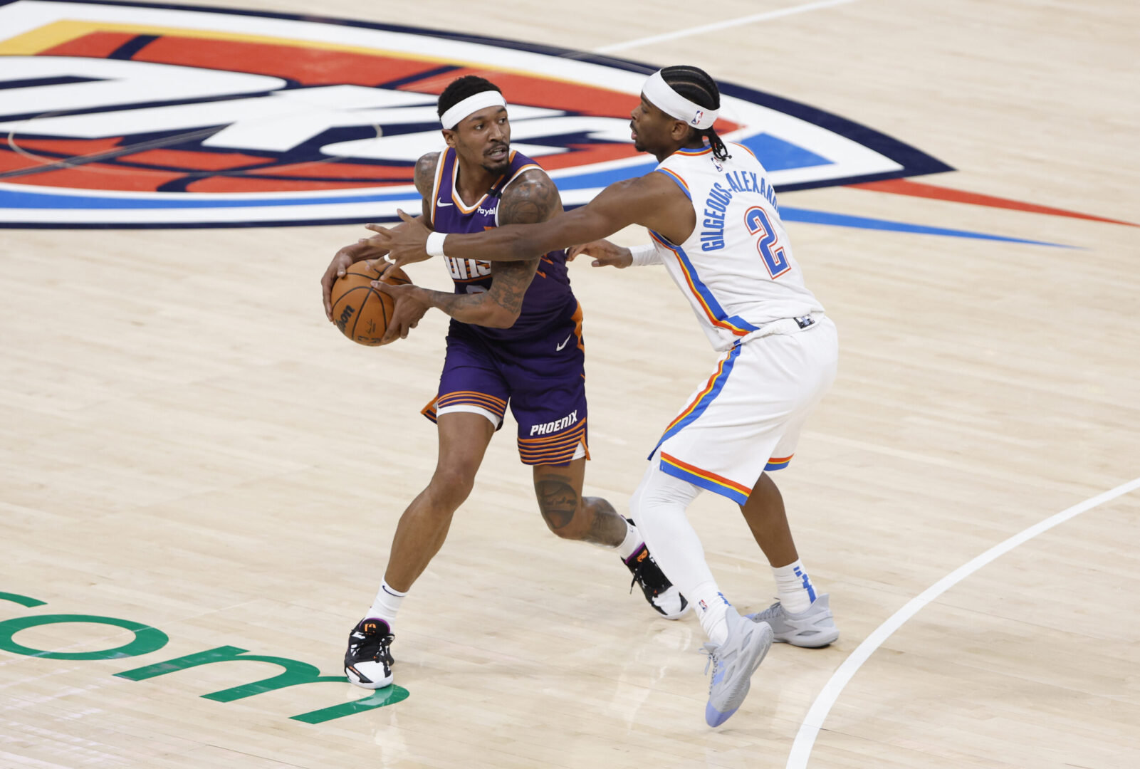 Feb 5, 2025; Oklahoma City, Oklahoma, USA; Phoenix Suns guard Bradley Beal (3) is defended by Oklahoma City Thunder guard Shai Gilgeous-Alexander (2) during the first half of a game at Paycom Center. Mandatory Credit: Alonzo Adams-Imagn Images